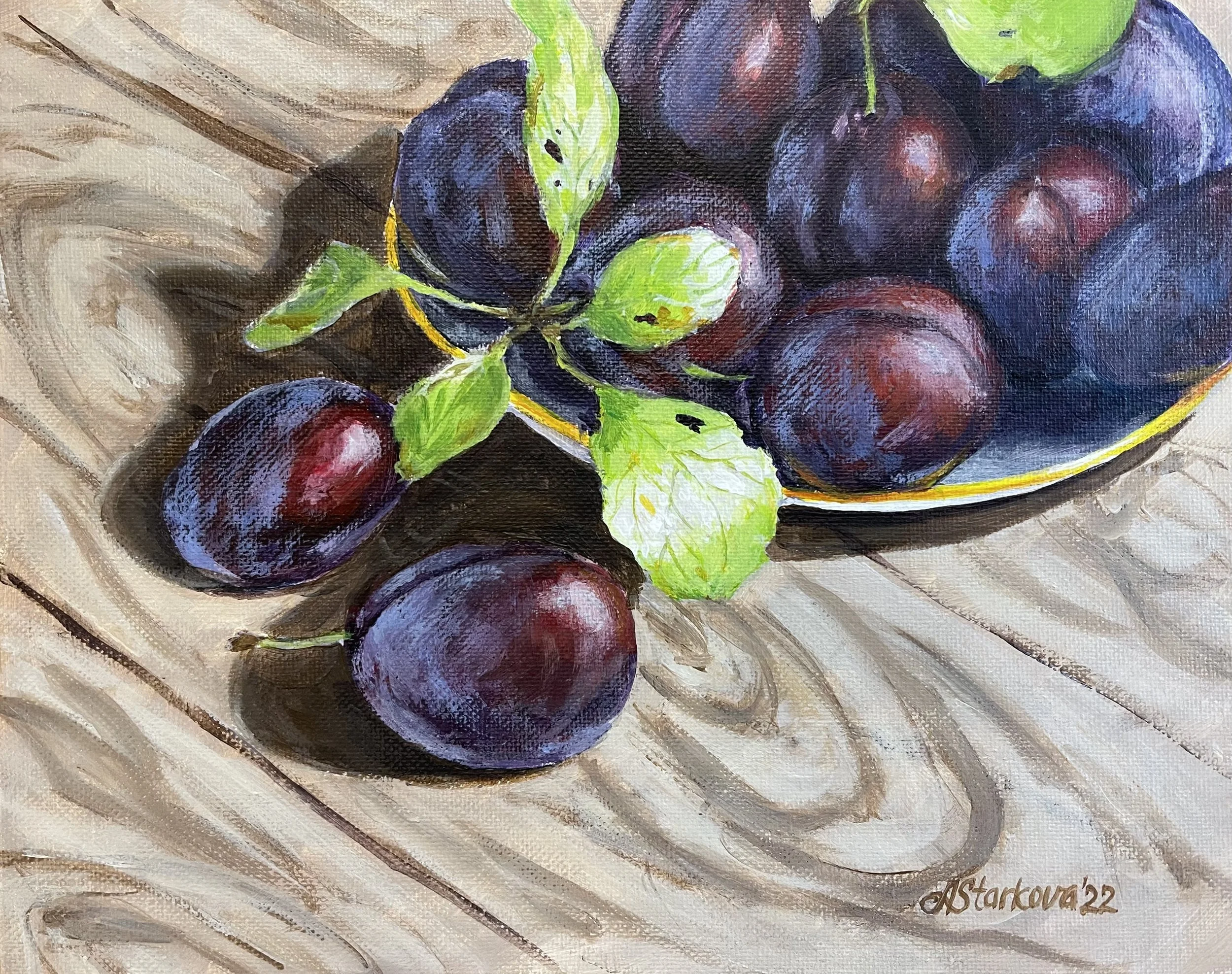 A still life painting depicting a bunch of dark purple plums with green leaves, resting on a wooden table.