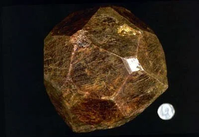 Famous Kunz "Subway? or Sewer?" Garnet - Weighing in at roughly nine pounds and used for years as a door stop at the Department of Public Works, this garnet dodecahedron is the most famous mineral specimen from Manhattan Island. Rumored to have been 