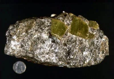 Chrysoberyl - One of the more spectacular specimens collected from the bedrock of New York City. Chrysoberyl is a rare, complex beryllium aluminosilicate that occurs in granitic rocks and pegmatites and in mica schist. This chrysoberyl cluster is ass