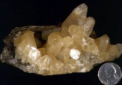 Calcite - Found in association with the Inwood Marble formation, these yellowish crystals were found in a cavity in the Inwood Marble near 174th Street and G'D Blvd., The Bronx. Manchester Collection #750.
