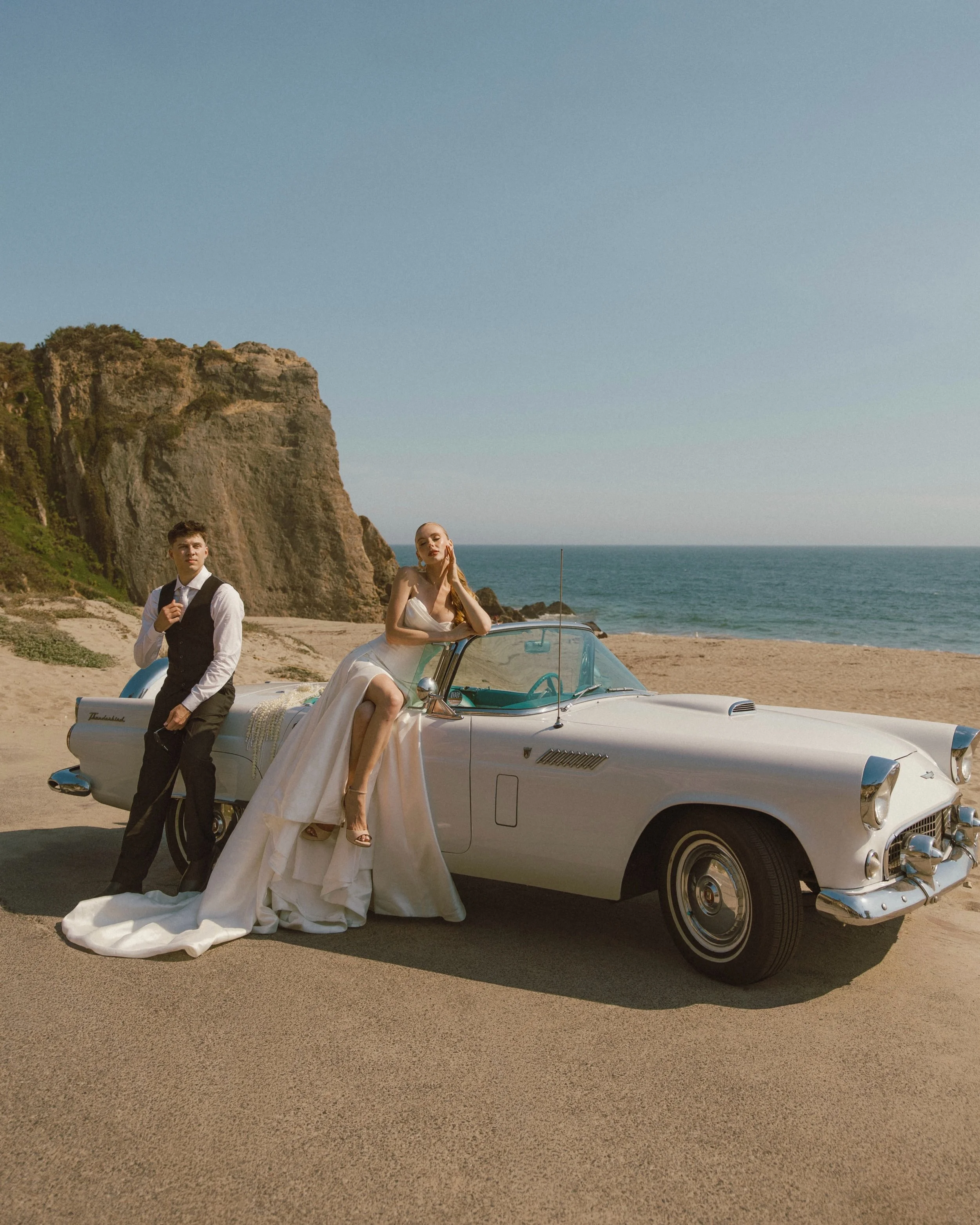 Sun-soaked skies, a vintage thunderbird, and lots of love

Credits:
Creative Direction: @theicon.academy
Founder / Concept: @ana.aleinikava
Bridal Gowns: @velvethour_la
Classic Car Rental: @beachgypsyclassics
Florals: @floralcode.la
MUA / Hair / Styl