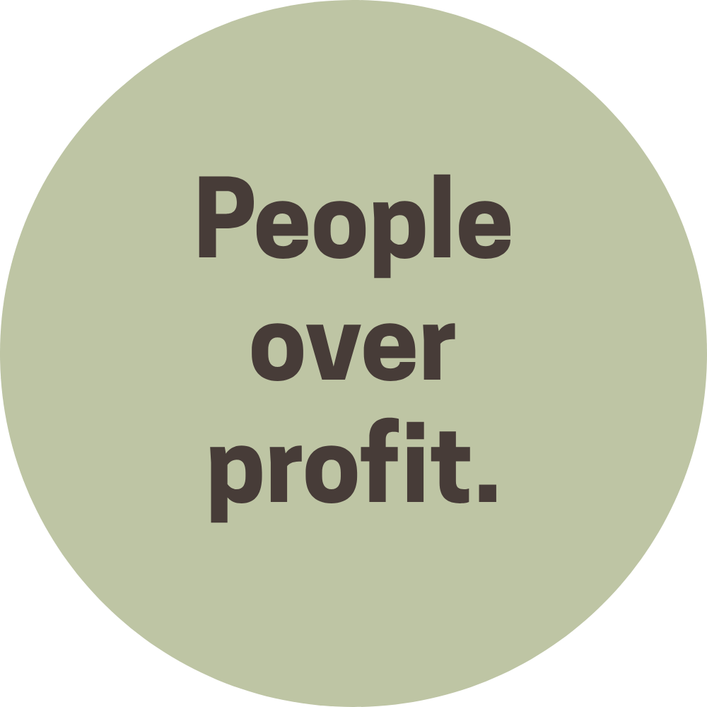 A round, pale green badge with dark gray text that reads "People over profit."