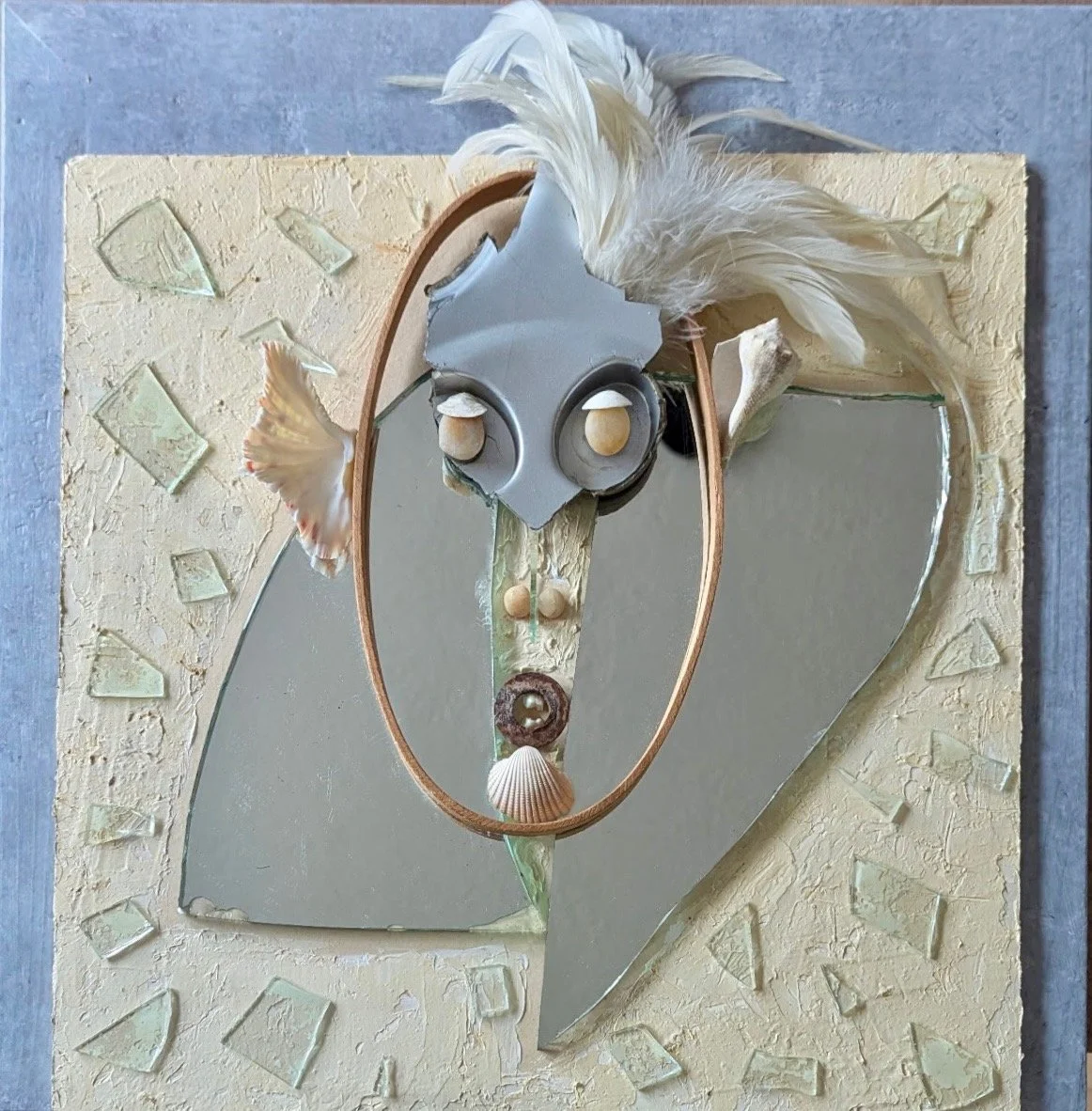  Reconstruction , 2026. Plastic, rooster feathers, shells, pebbles, glass, steel, human teeth, mirror, acrylic on wood – 16" X 16" X 3"