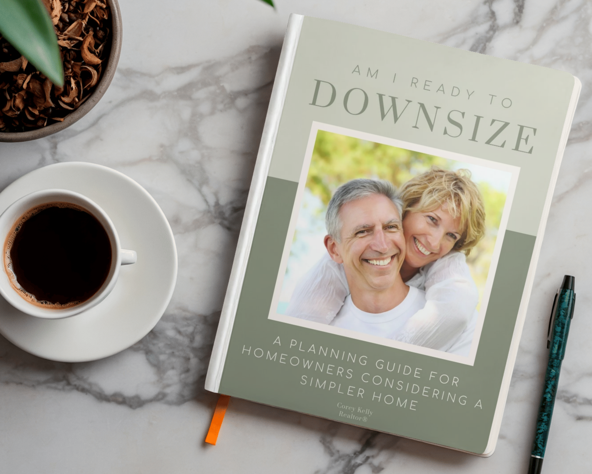 A book titled 'Am I Ready to Downsize' with a smiling couple's photo on the cover. The book is on a marble surface next to a cup of coffee and a bowl of cinnamon sticks, with a potted green plant nearby.