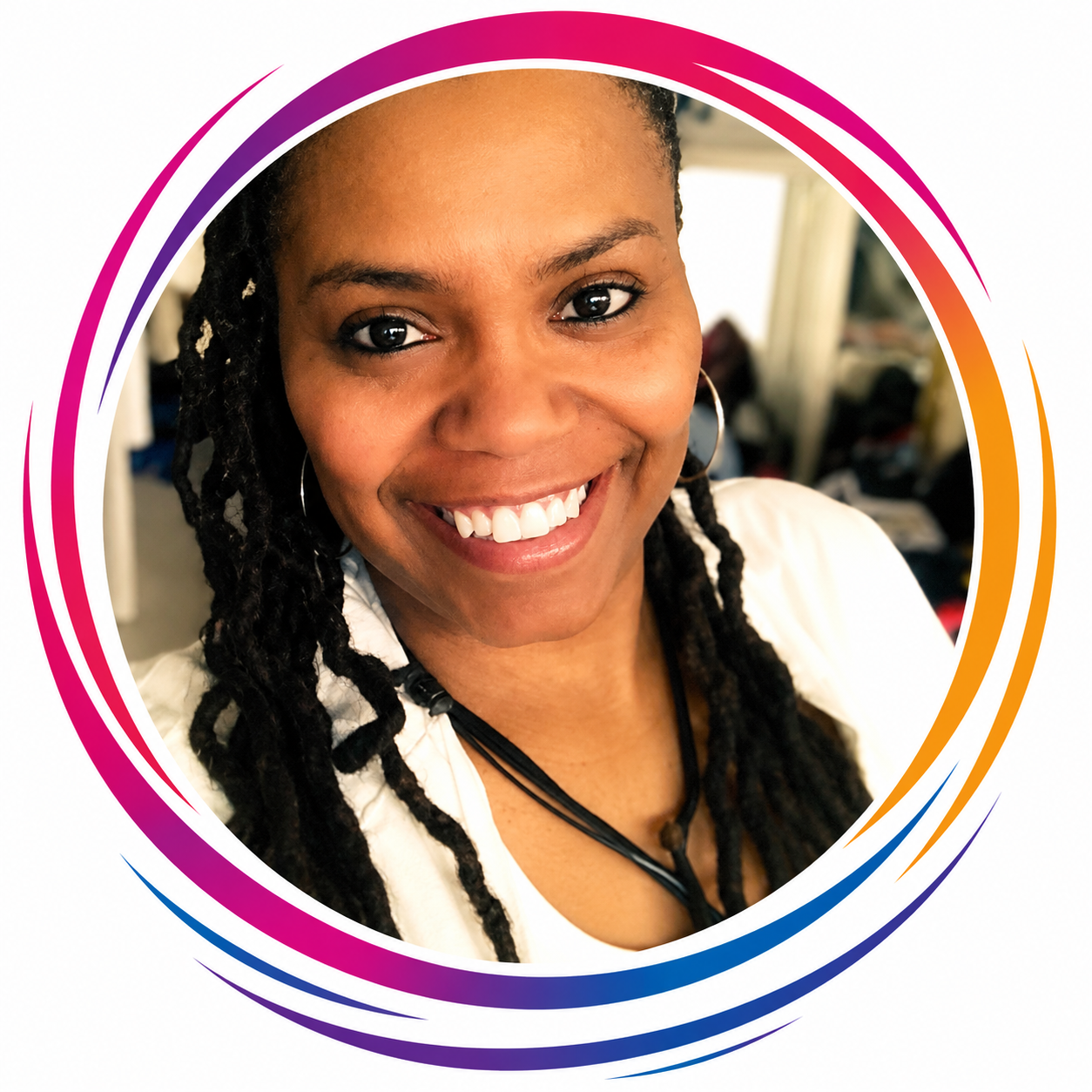 A smiling woman with braided hair, hoop earrings, wearing a white top, posing for a portrait with a colorful circular border in the background.