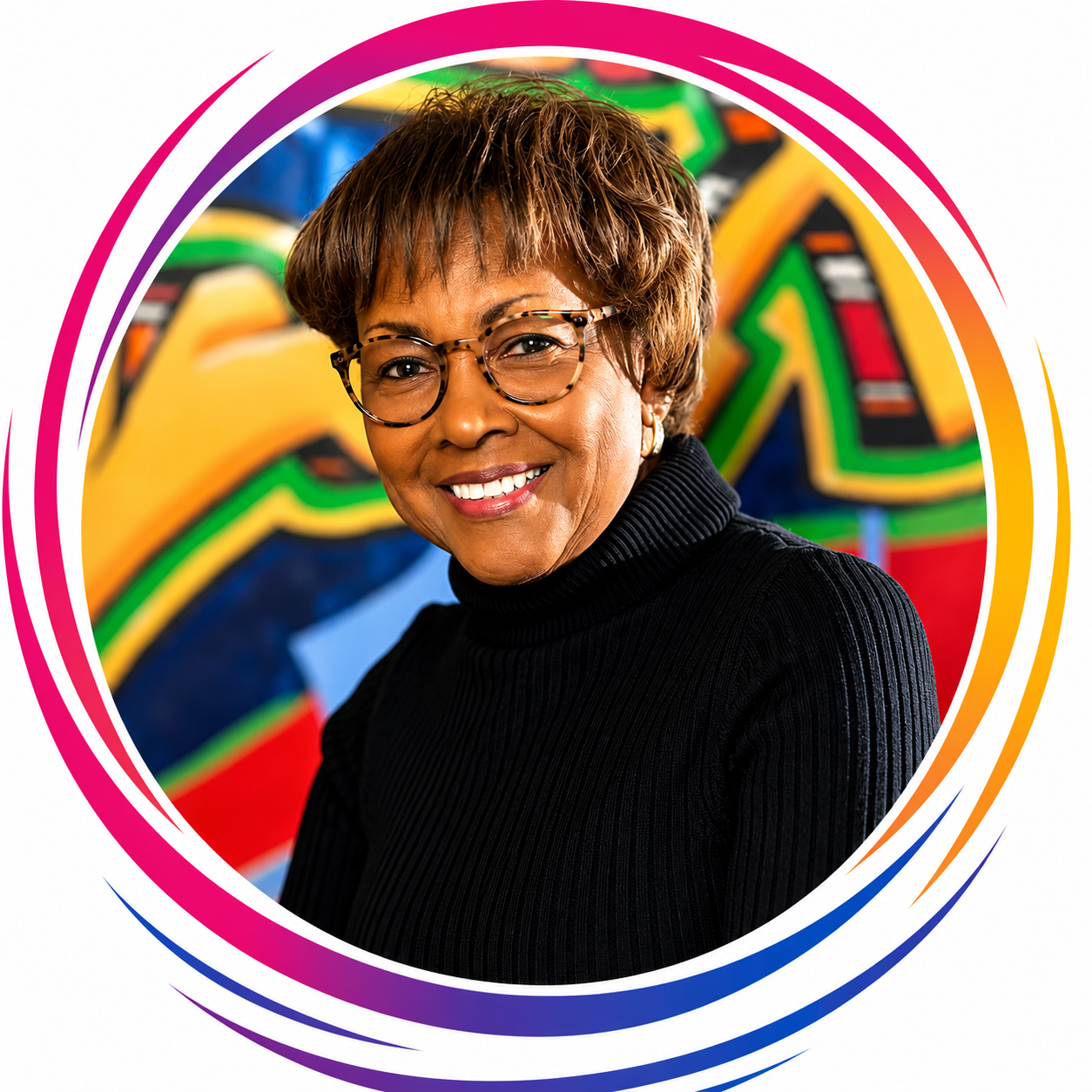 A smiling woman with short brown hair, glasses, and earrings, wearing a black turtleneck, standing in front of a colorful graffiti background.