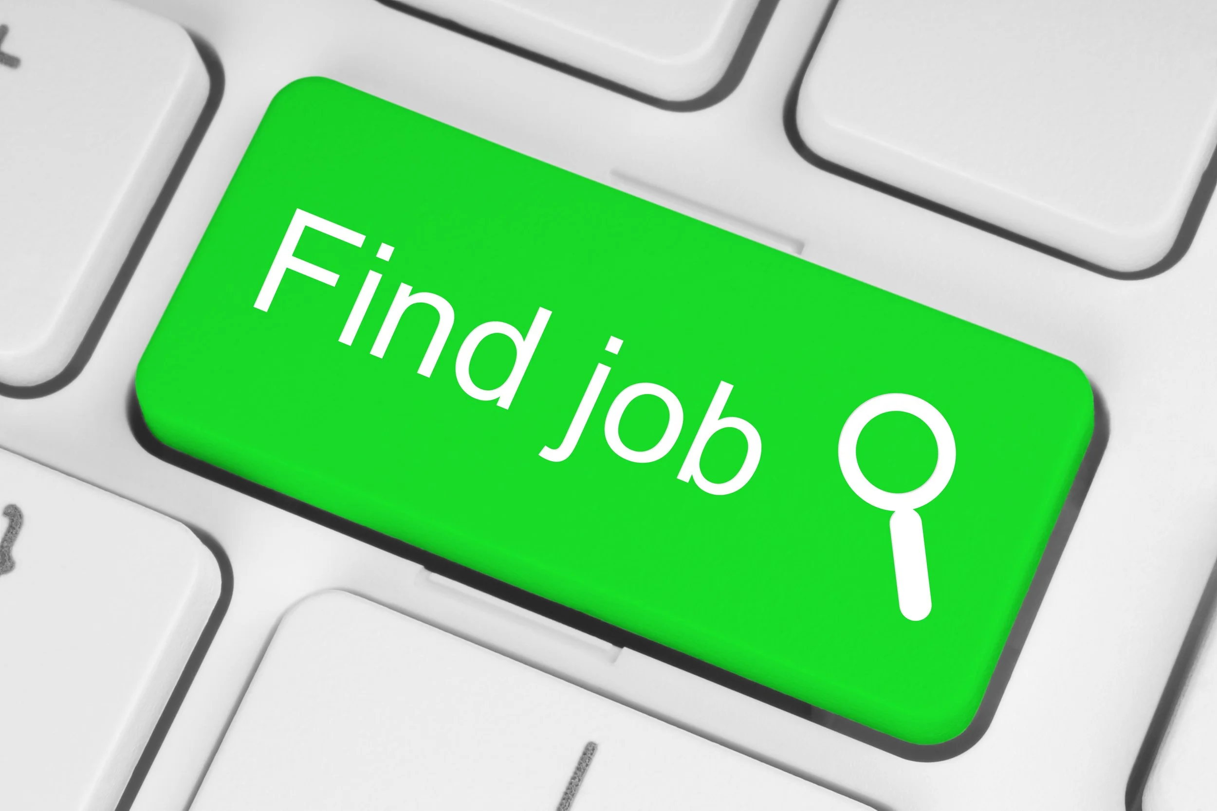 Green keyboard key set in a white keyboard that says find a job with an image of a magnify glass.