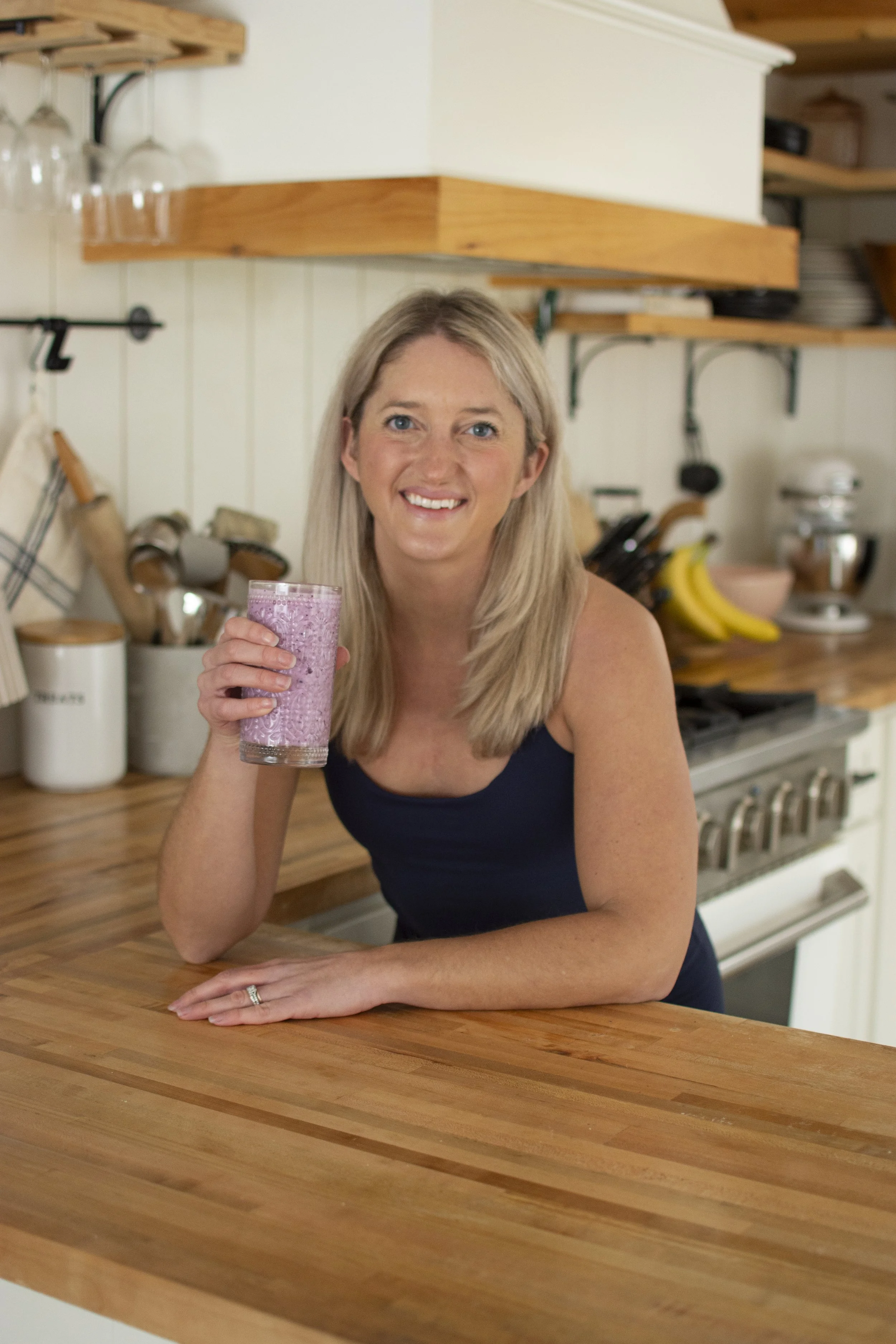 Registered Dietitian Kileigh Job with a fresh berry smoothie in her kitchen