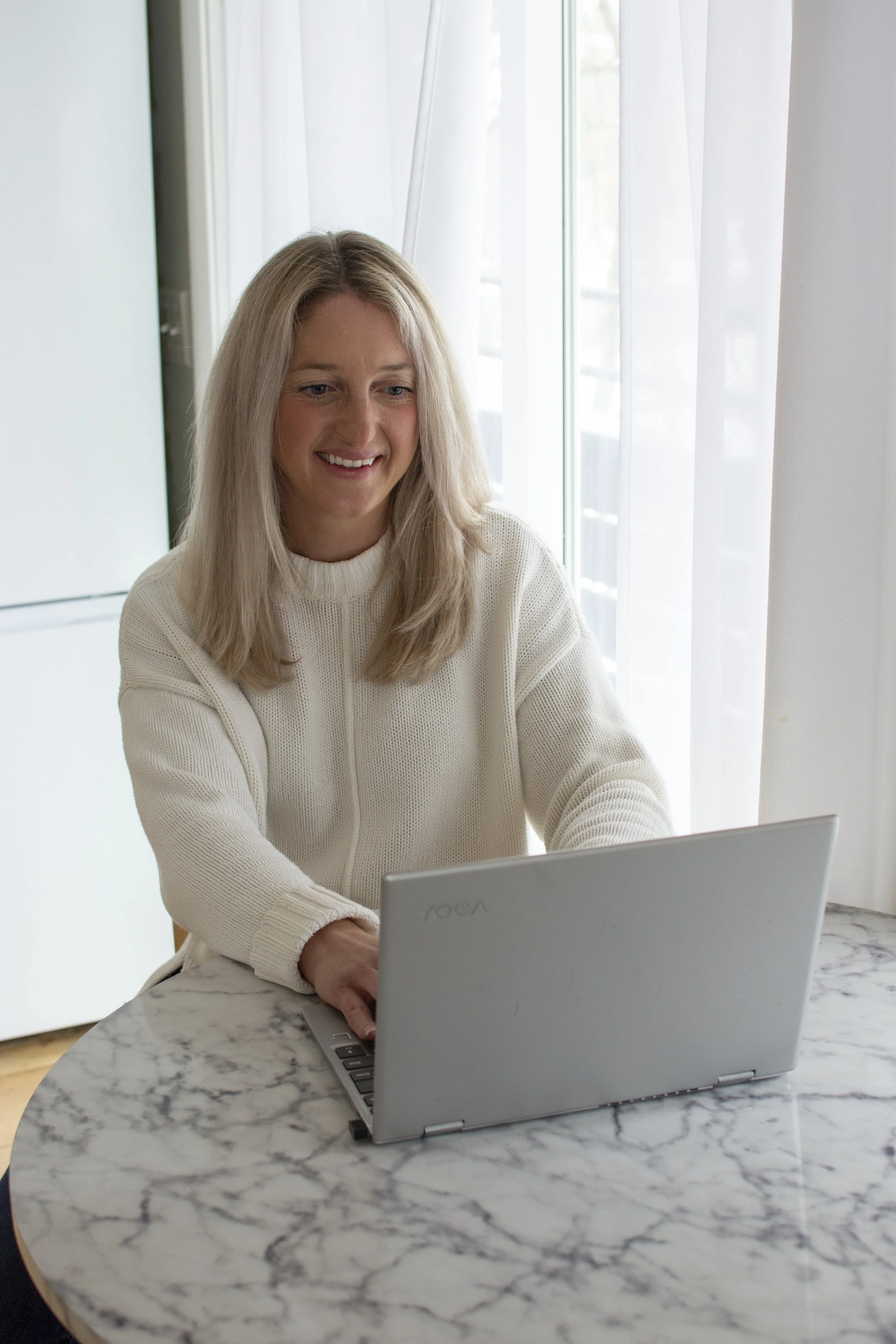 Registered Dietitian Kileigh Job at her laptop during a virtual nutrition counseling session