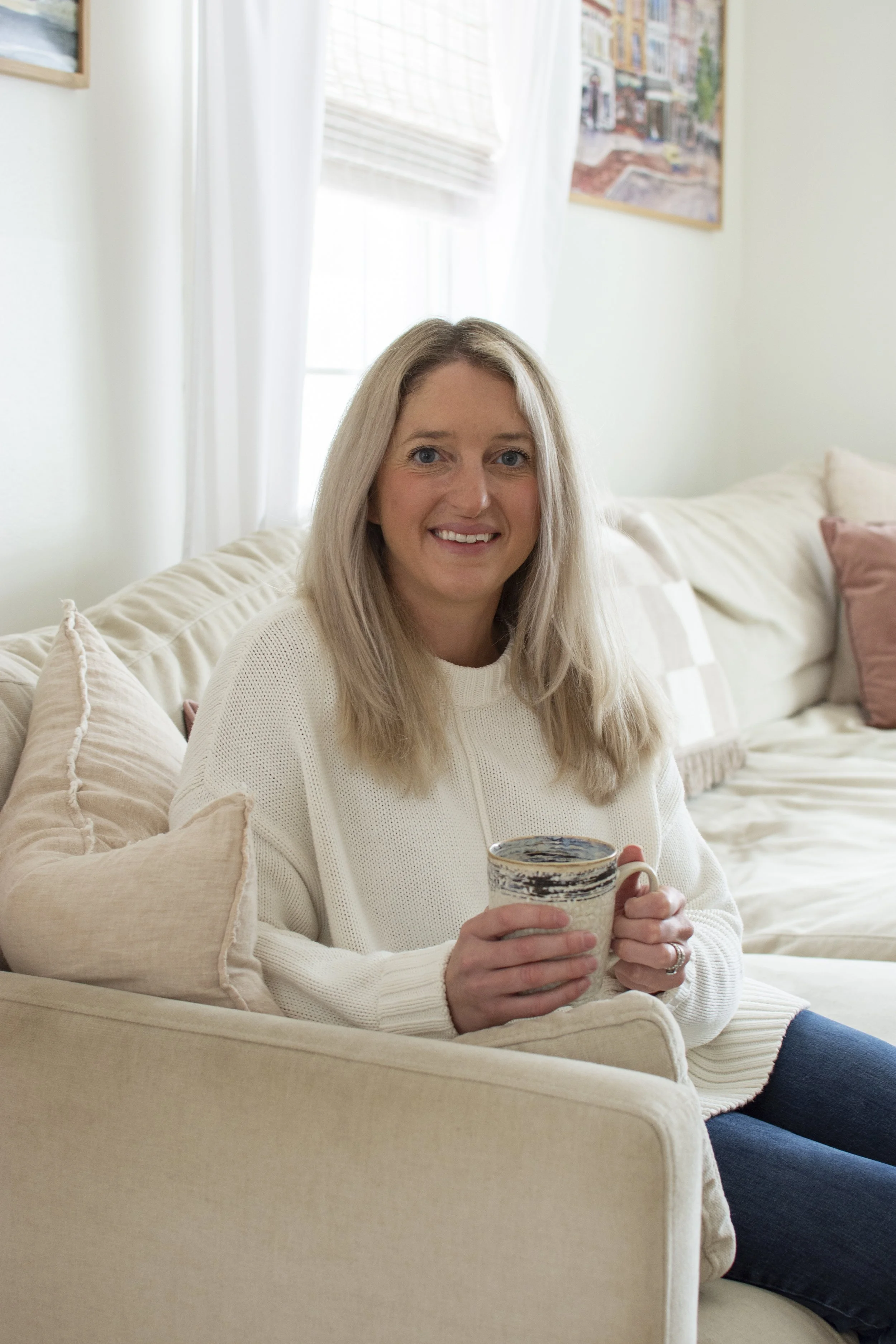 Registered Dietitian Kileigh Job relaxing with a warm drink at home in Upstate New York