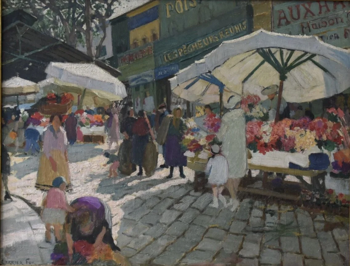 People shopping at an outdoor flower market with vendors under umbrellas on a sunny day.