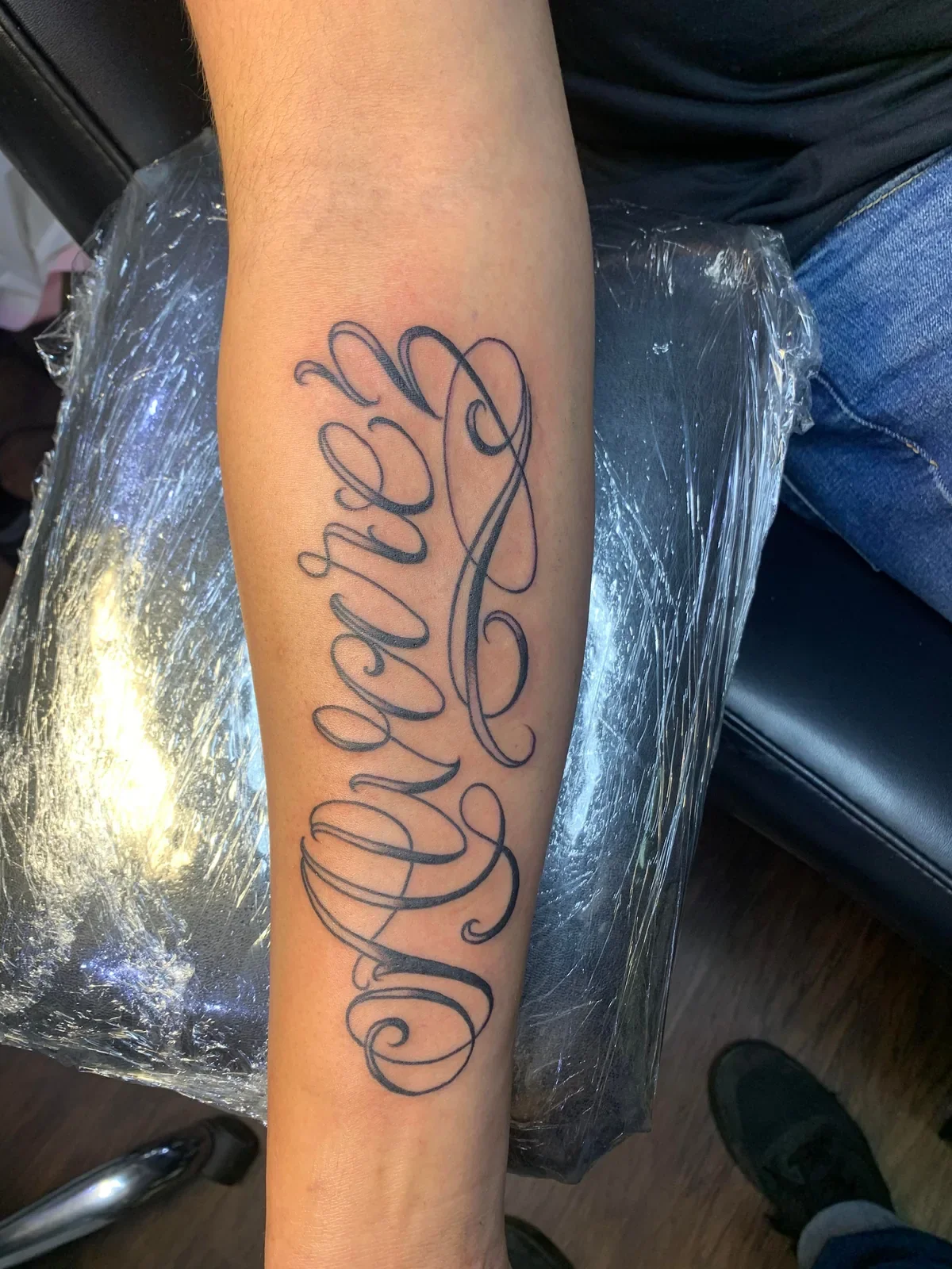 Custom cursive script "Alvarez" — flowing single-needle style lettering with elegant loops and tapers.
