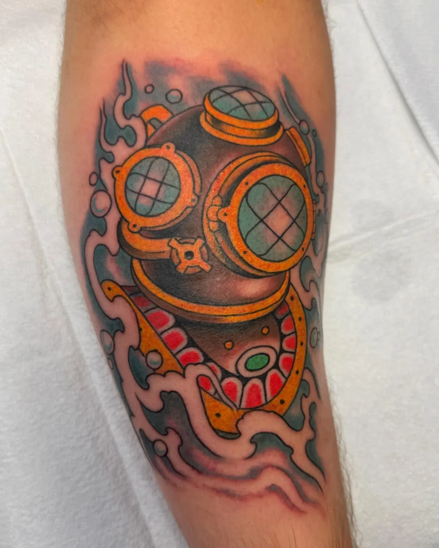 Color traditional deep sea diver helmet tattoo with bubbles and waves. Bold nautical traditional piece with orange and teal accents by Brett Semrick.
