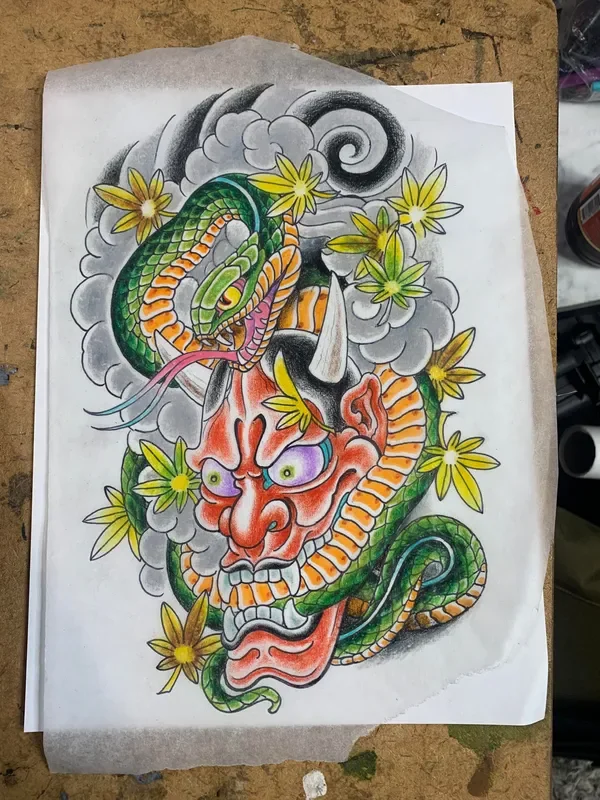 Traditional Japanese painting of red hannya demon mask with white horns and purple eyes, coiled by green and orange hebi snake. Surrounded by yellow momiji maple leaves and grey kumo clouds. Colored pencil and ink on tracing paper. Explores protectio