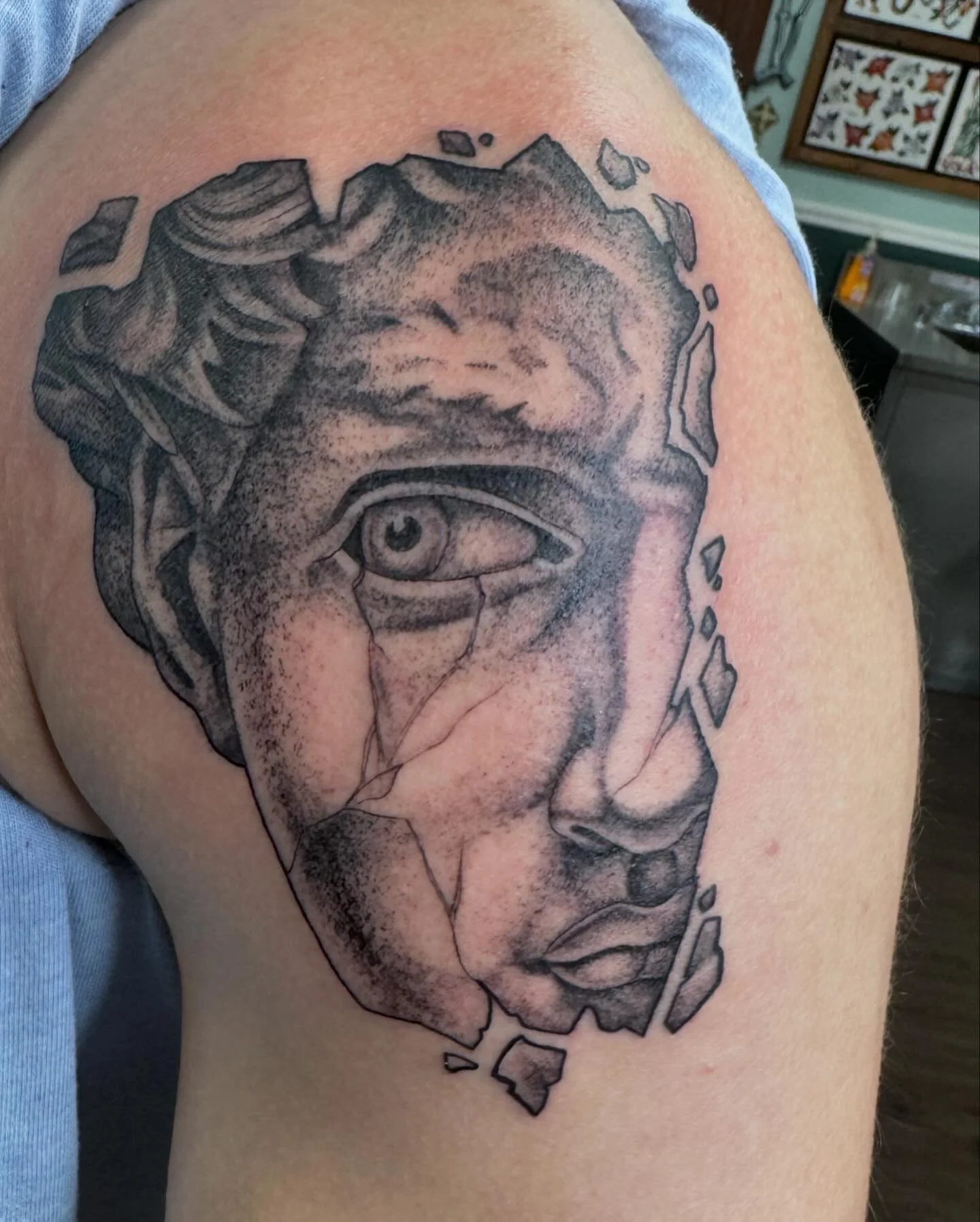 Detail study of Michelangelo's David as a cracked marble statue with realistic eye. Micro-realism and illustrative dotwork.
