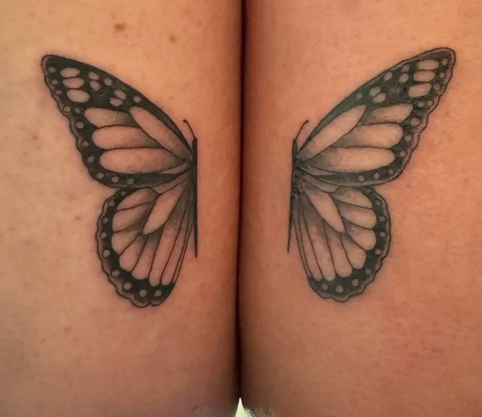 Delicate black and gray butterfly wings split across arms, creating a full butterfly when together. Fine line and soft shading by San Diego tattoo artist Brett Semrick.