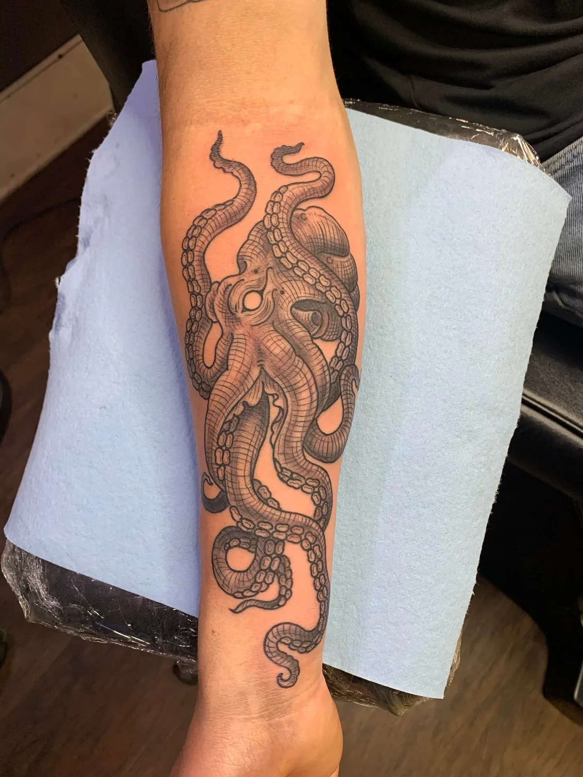 Forearm-wrapping octopus — cross-hatch tentacles, bold outline, built to flow with the arm.
