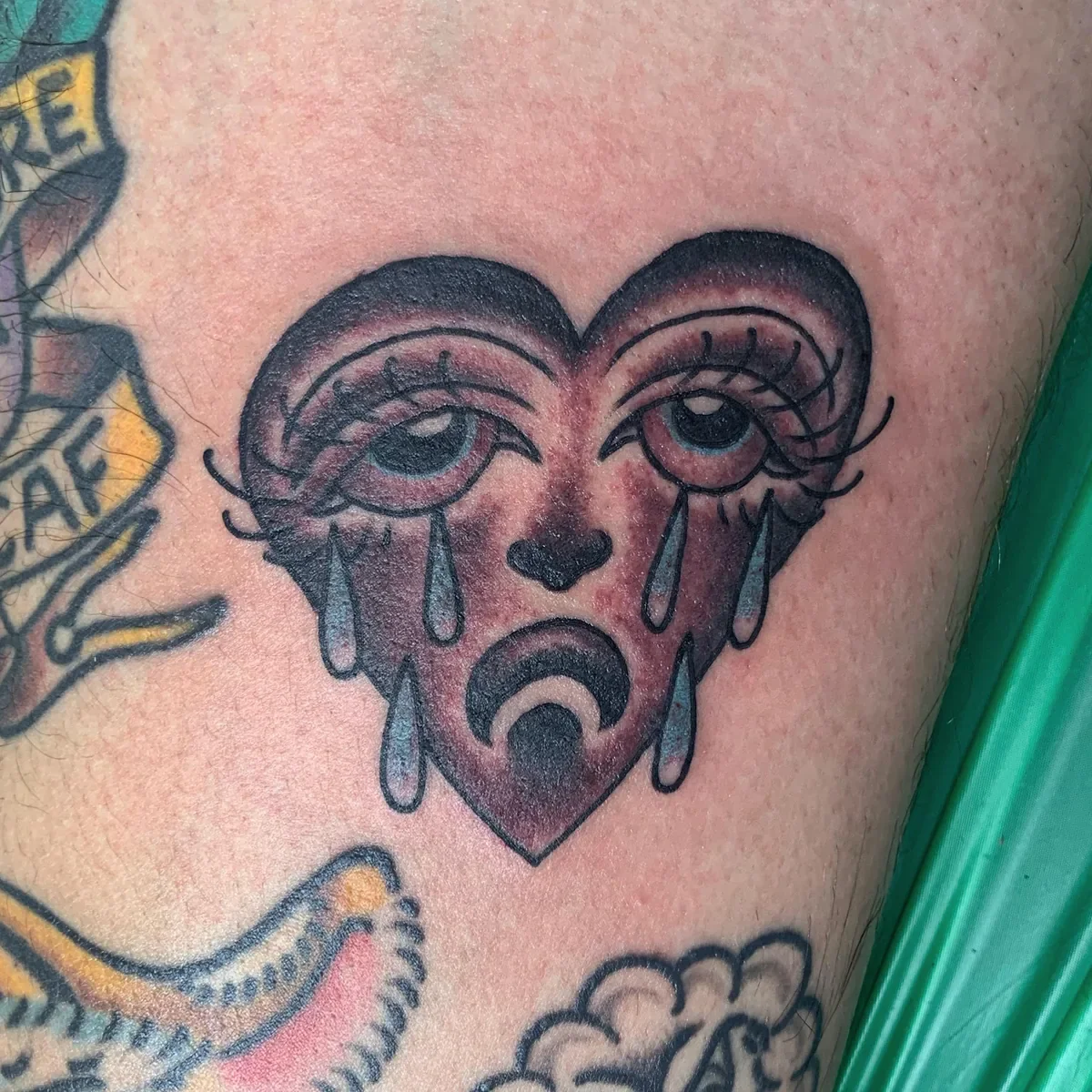 Traditional crying heart tattoo with expressive eyes and teardrops. Classic flash with modern shading 