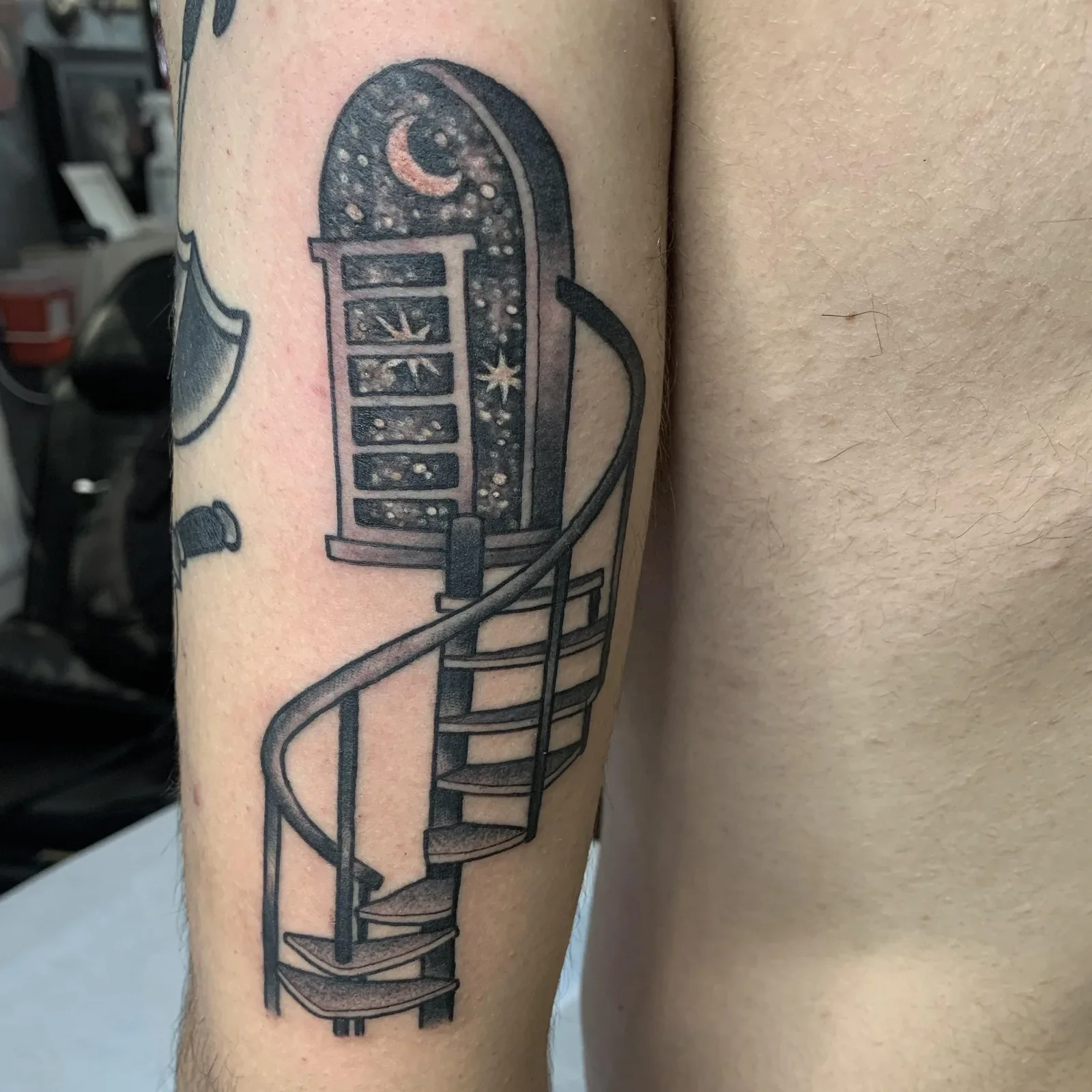Surreal staircase with arched doorway filled with moon, stars and cosmos — fine line blackwork surrealism.

