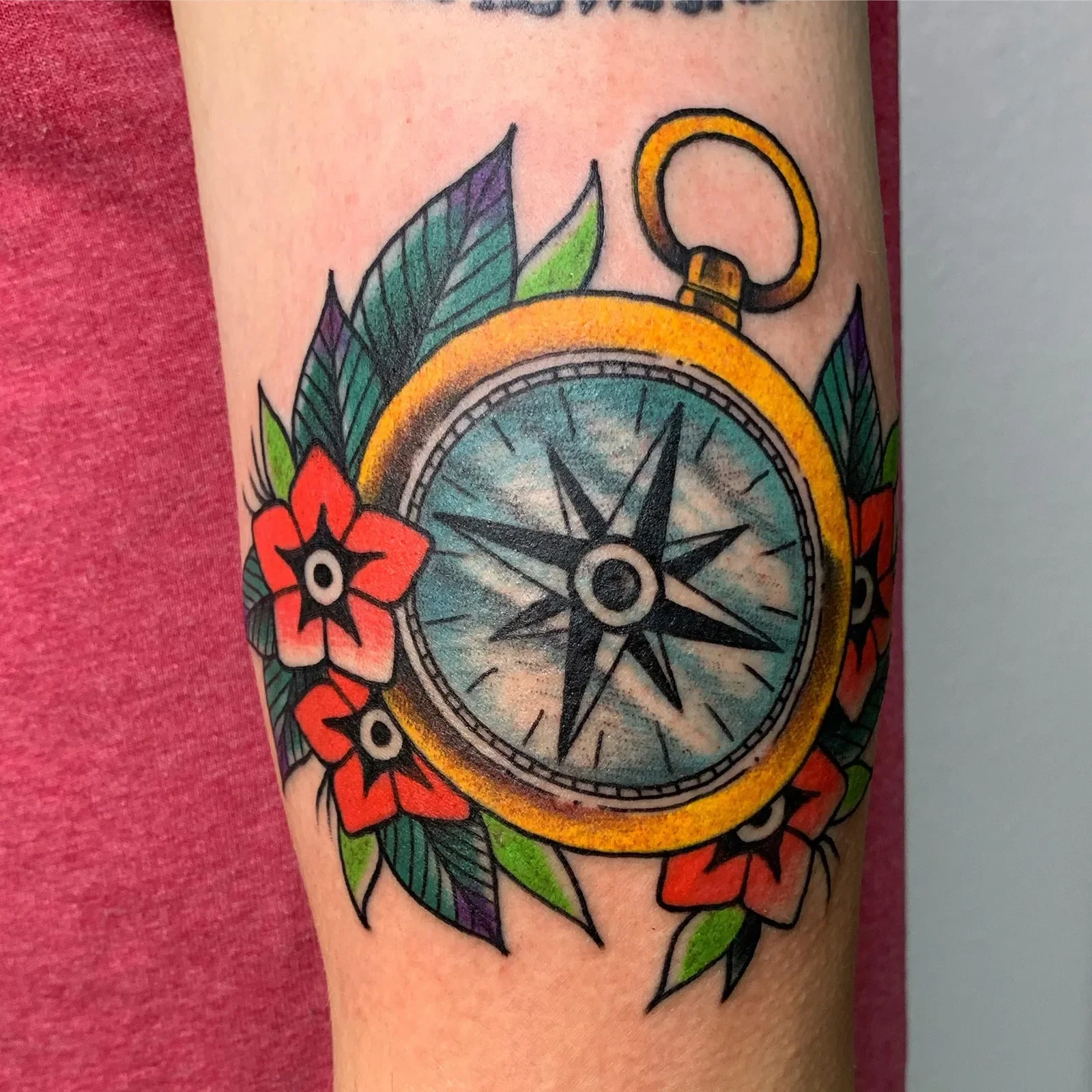  Nautical compass in full color traditional — golden case, black star, red star-flowers and foliage.
