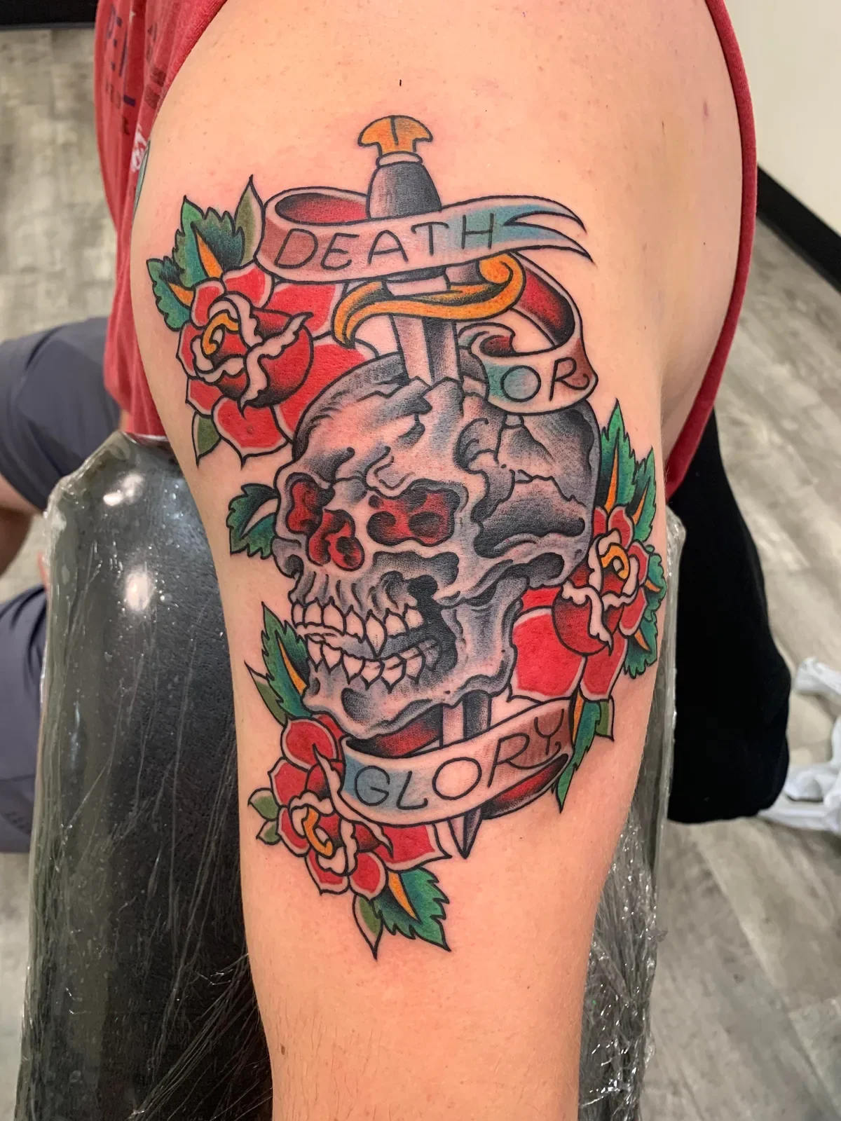 Classic "Death or Glory" banner, dagger through skull with three red roses — pure American traditional.
