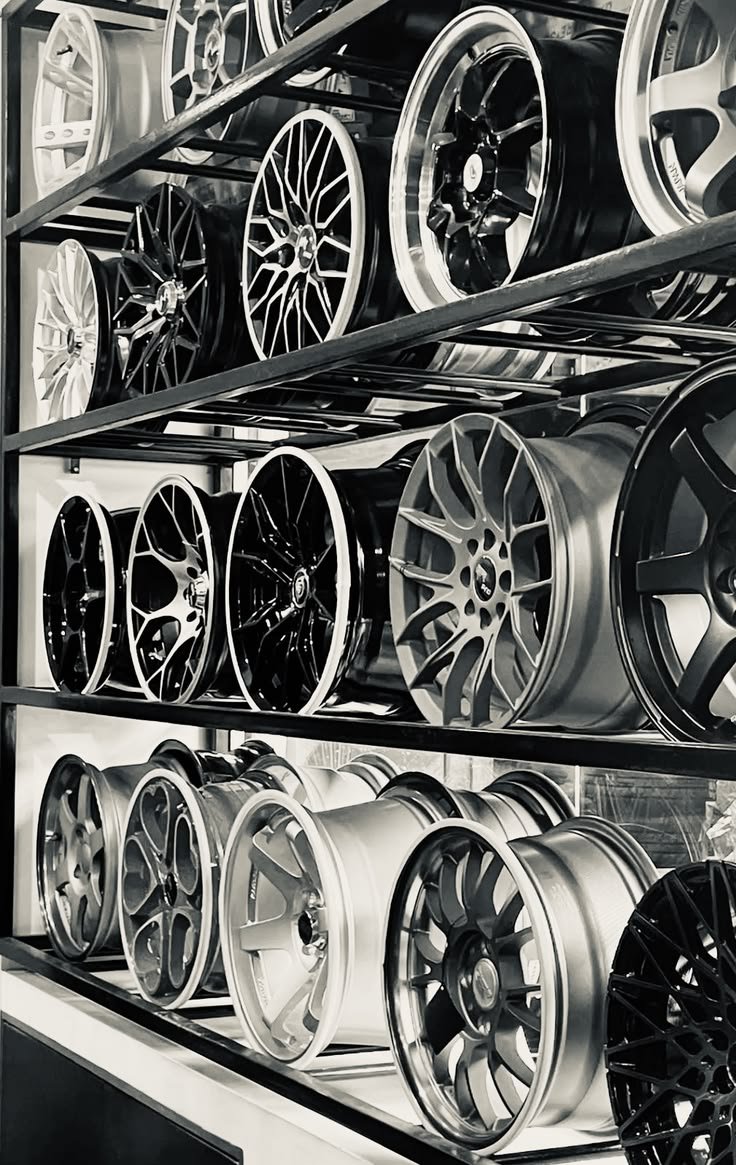 Custom aftermarket wheels and performance rims displayed on a rack for vehicle custom installs.