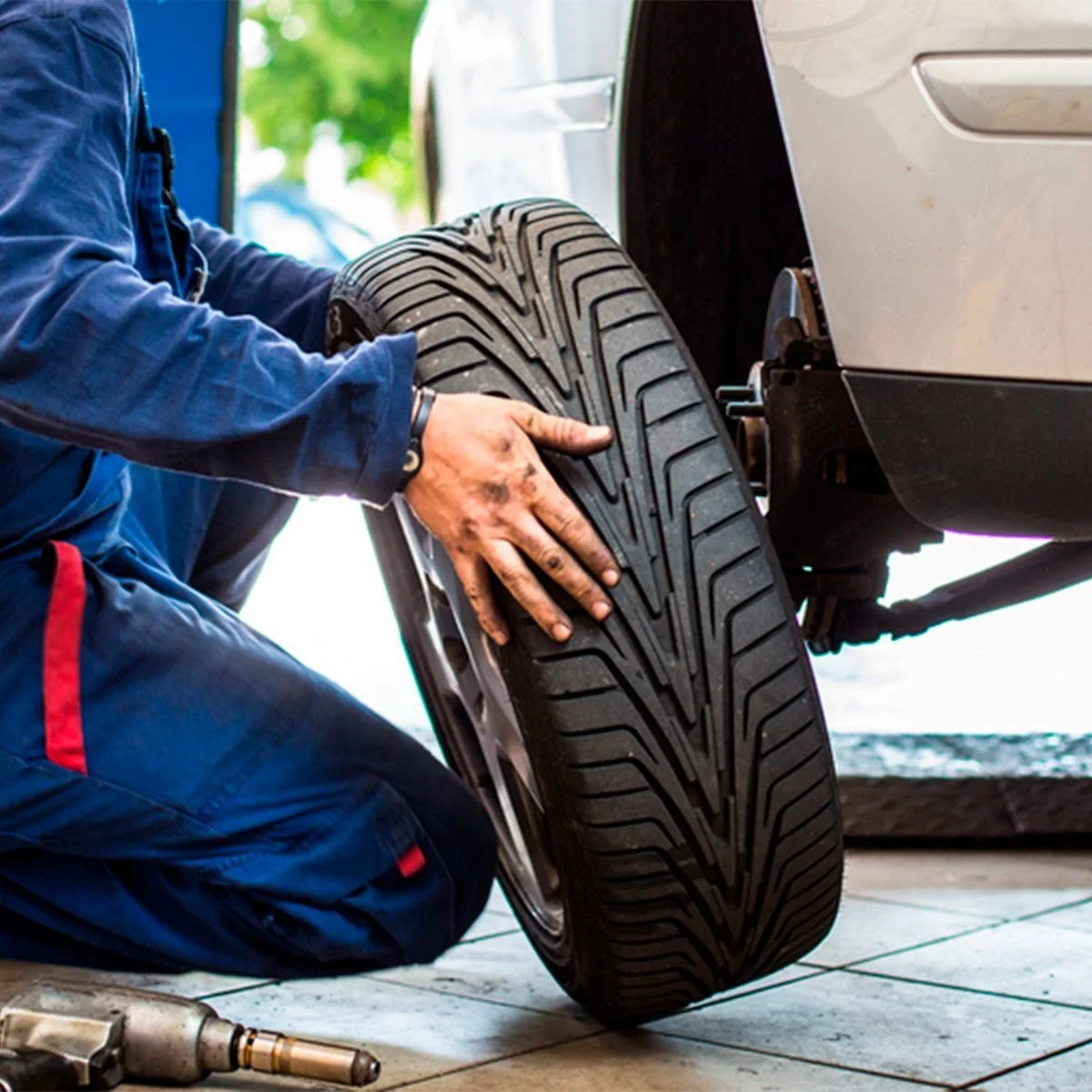 Installing a fresh tire on a vehicle wheel hub assembly during tire service.