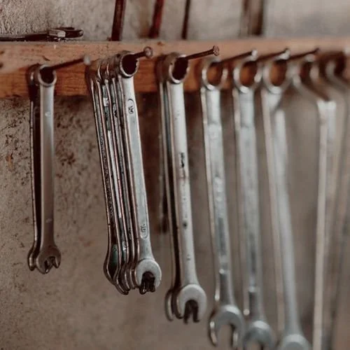 Set of shop wrenches organized for professional automotive mechanical repair.