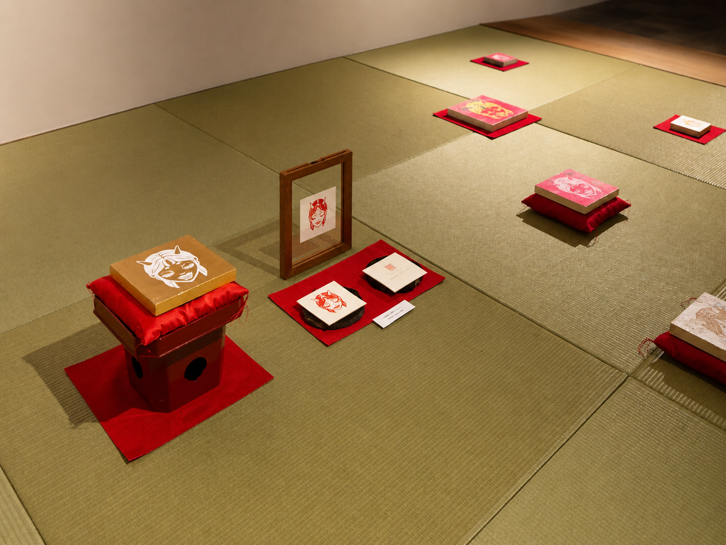 Installation view of Oni as Guardian at Akagi Shrine in Kagurazaka, Tokyo, featuring Oniko artworks displayed on tatami and red cushions.