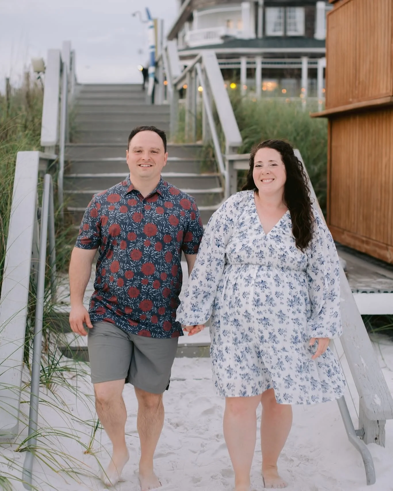 Adam and Kristen Ladenburger Holding Hands at the Bottom of the Stairs on a Beach