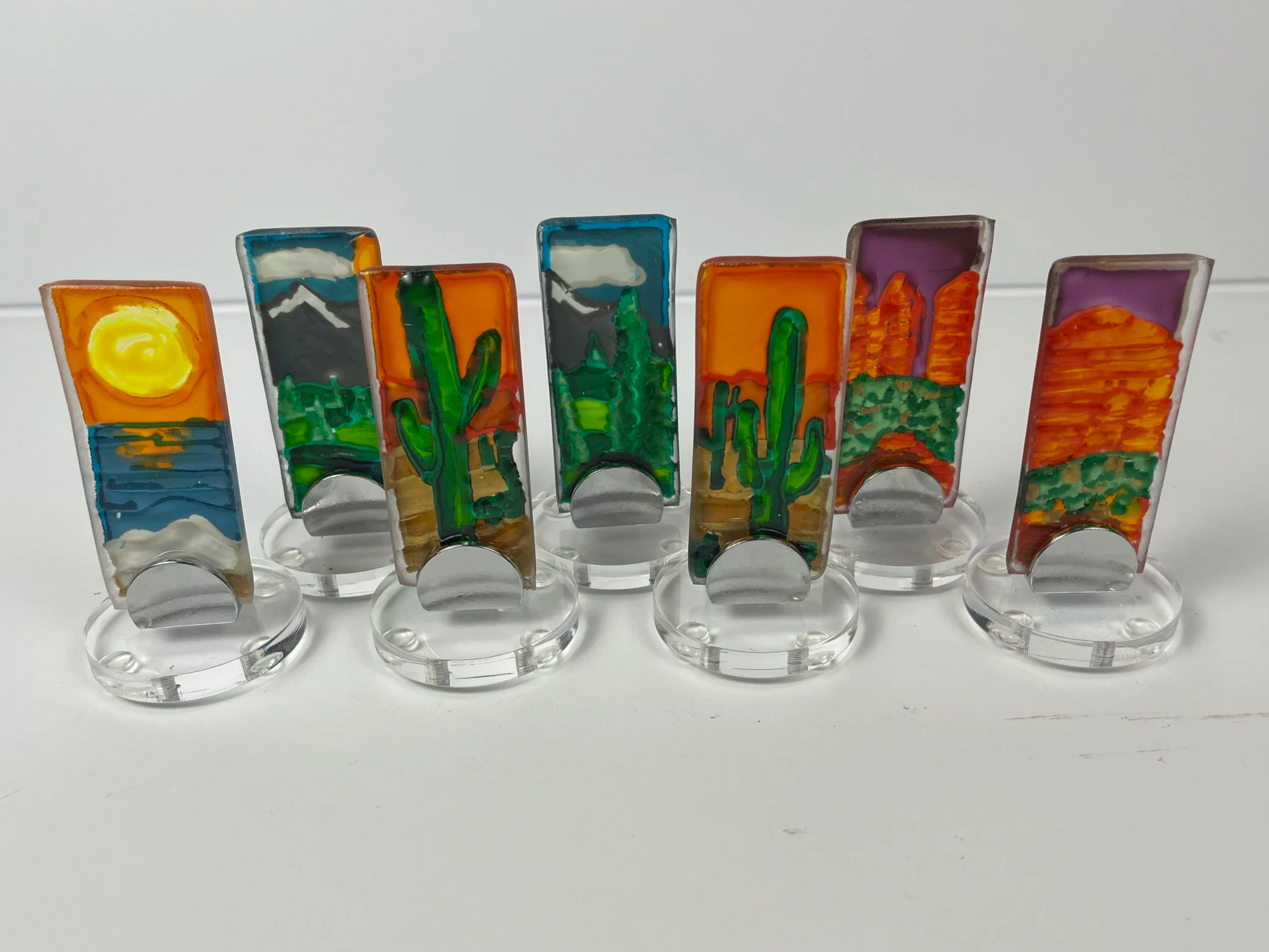 Small nature inspired textured glass stands featuring cactus, ocean, and mountain designs