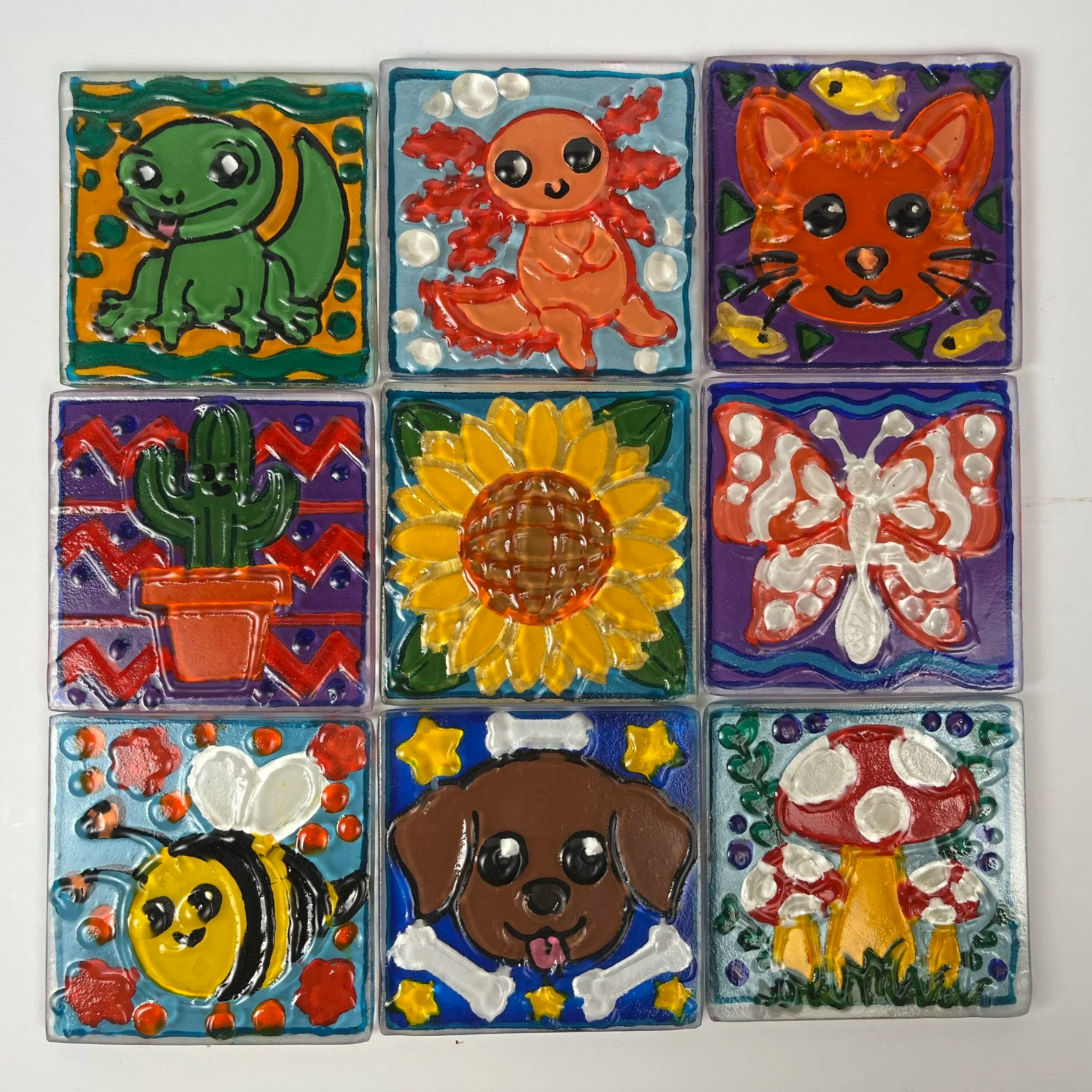 Little textured glass tiles hand painted with fun simple designs such as puppies, flowers, creatures, and nature