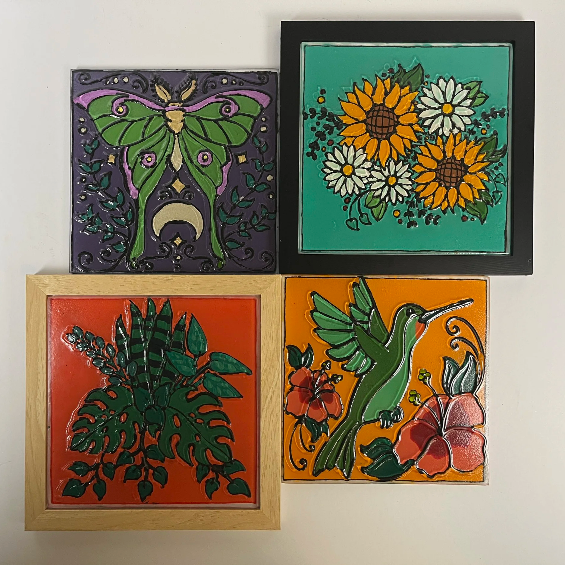 Large textured glass wall art with intricate illustrative hand-painted bold colorful designs displayed as wall art