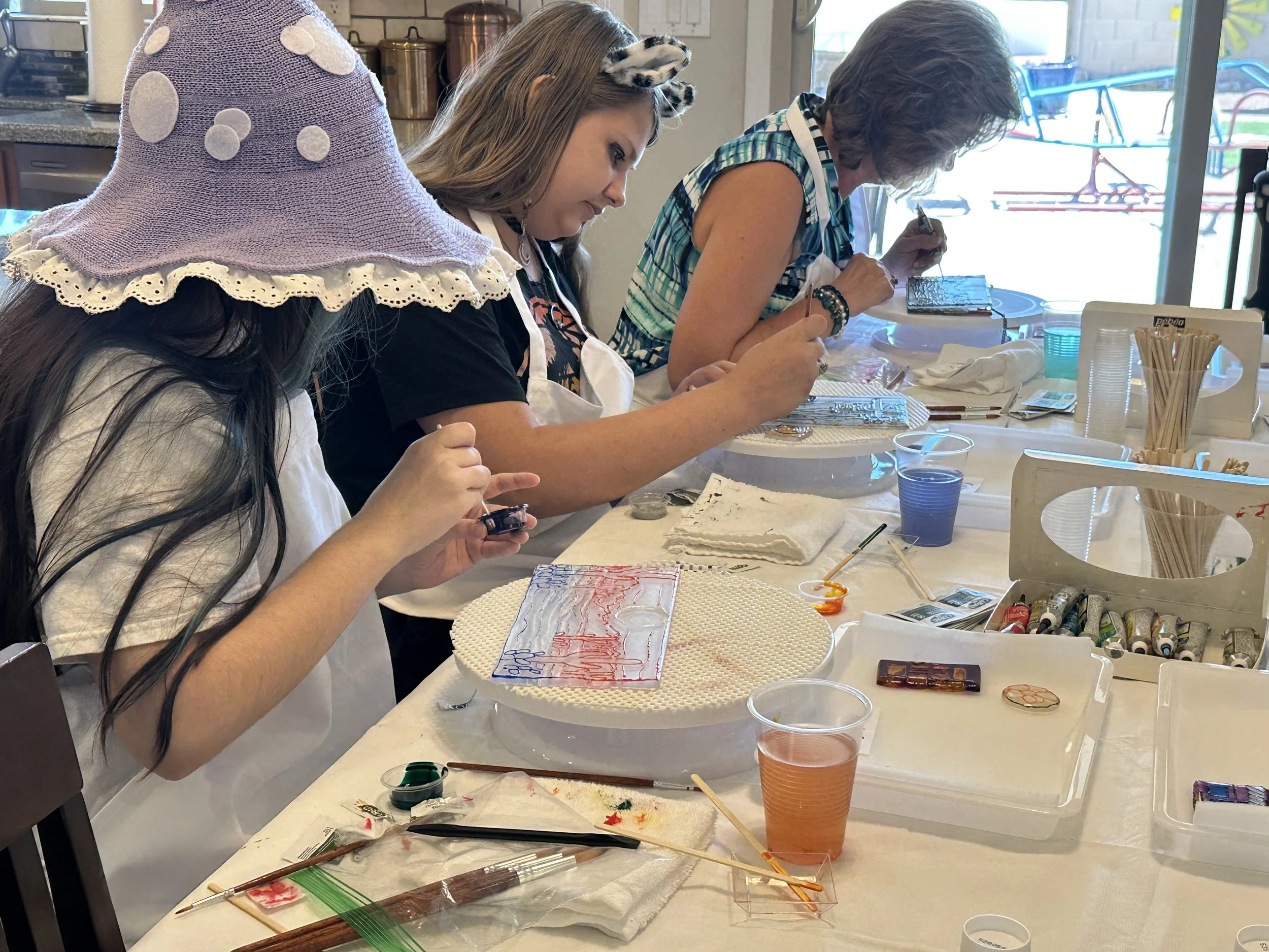 Glass painting party guests painting their glass projects