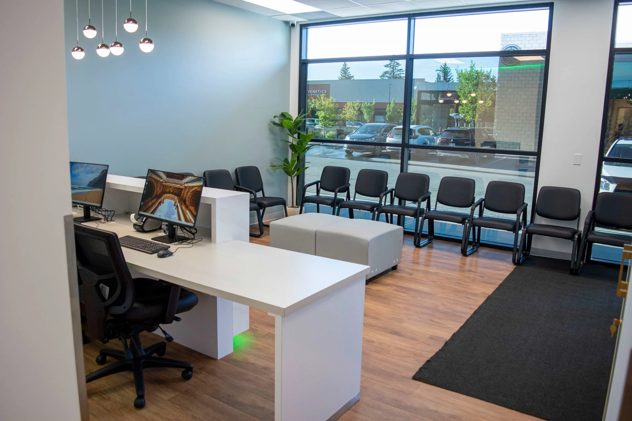 waiting area with numerous chairs and leather table for patients and visitors