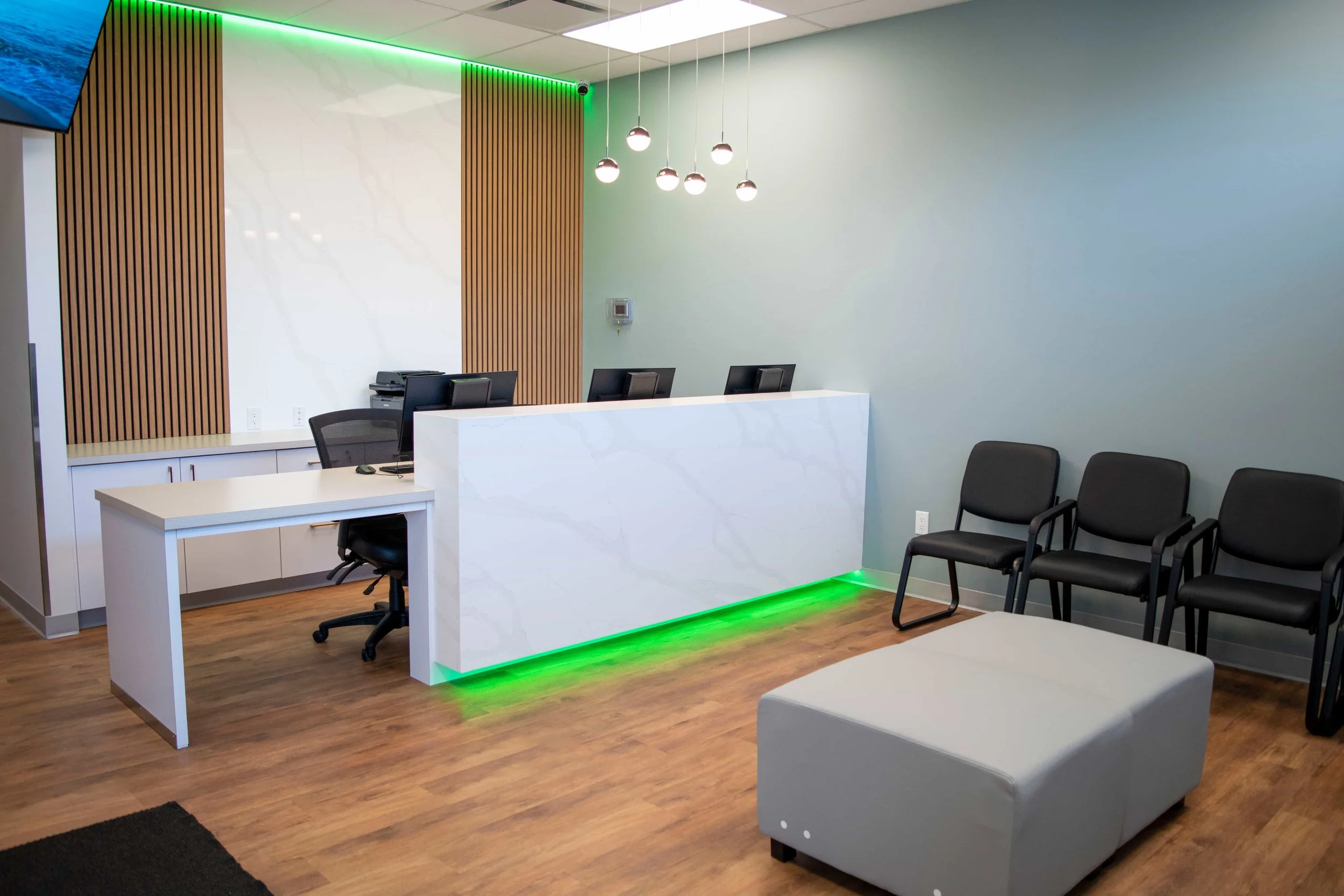waiting room with chairs and a leather center table for patients and visitors