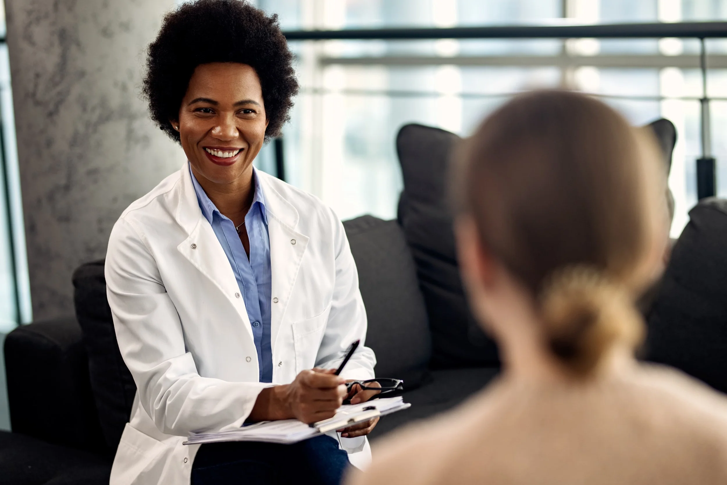 a female doctor talking to a patient