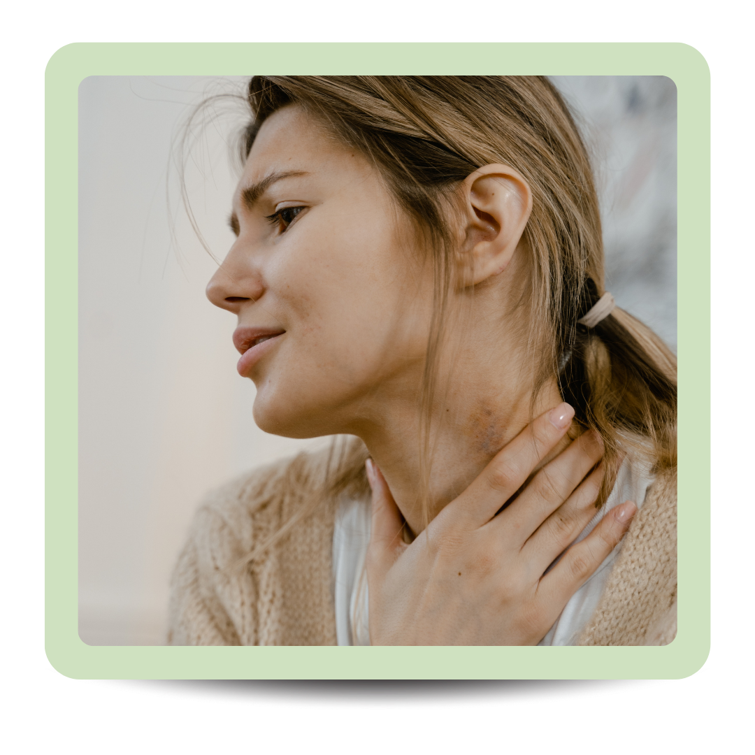 A woman holding her throat with her hand, appearing to be in discomfort or pain.