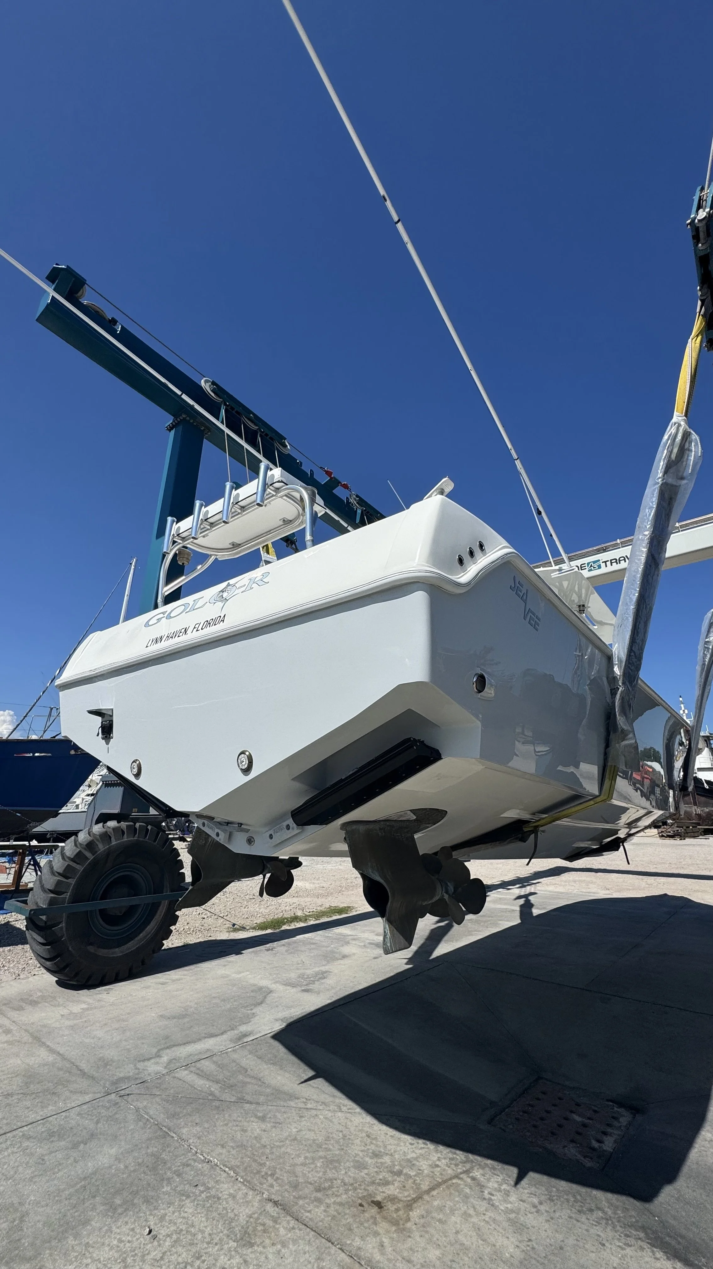 A boat being moved via marine lift on dry land