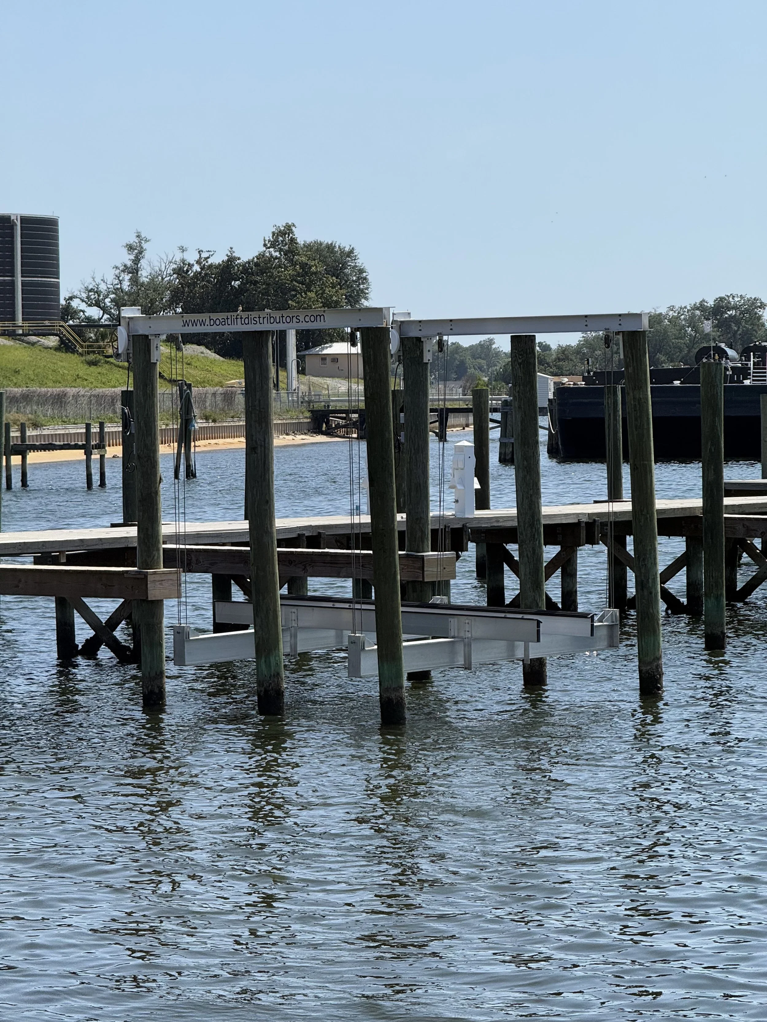 A picture of a dock with a boat lift at Panhandle Marina & Boatyard.