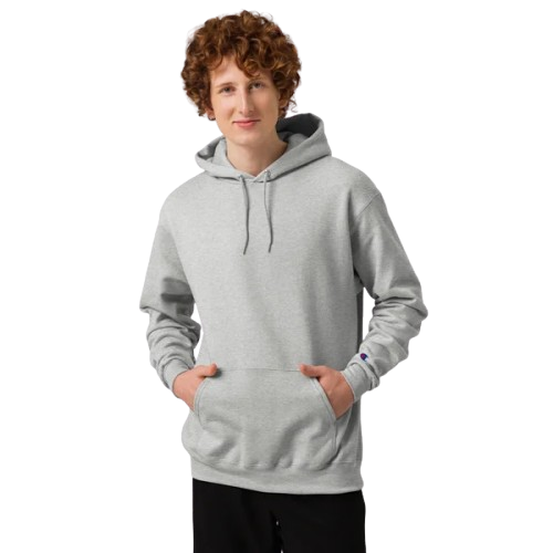 Young person with curly hair wearing a gray hoodie, standing with hands in pockets, smiling slightly.