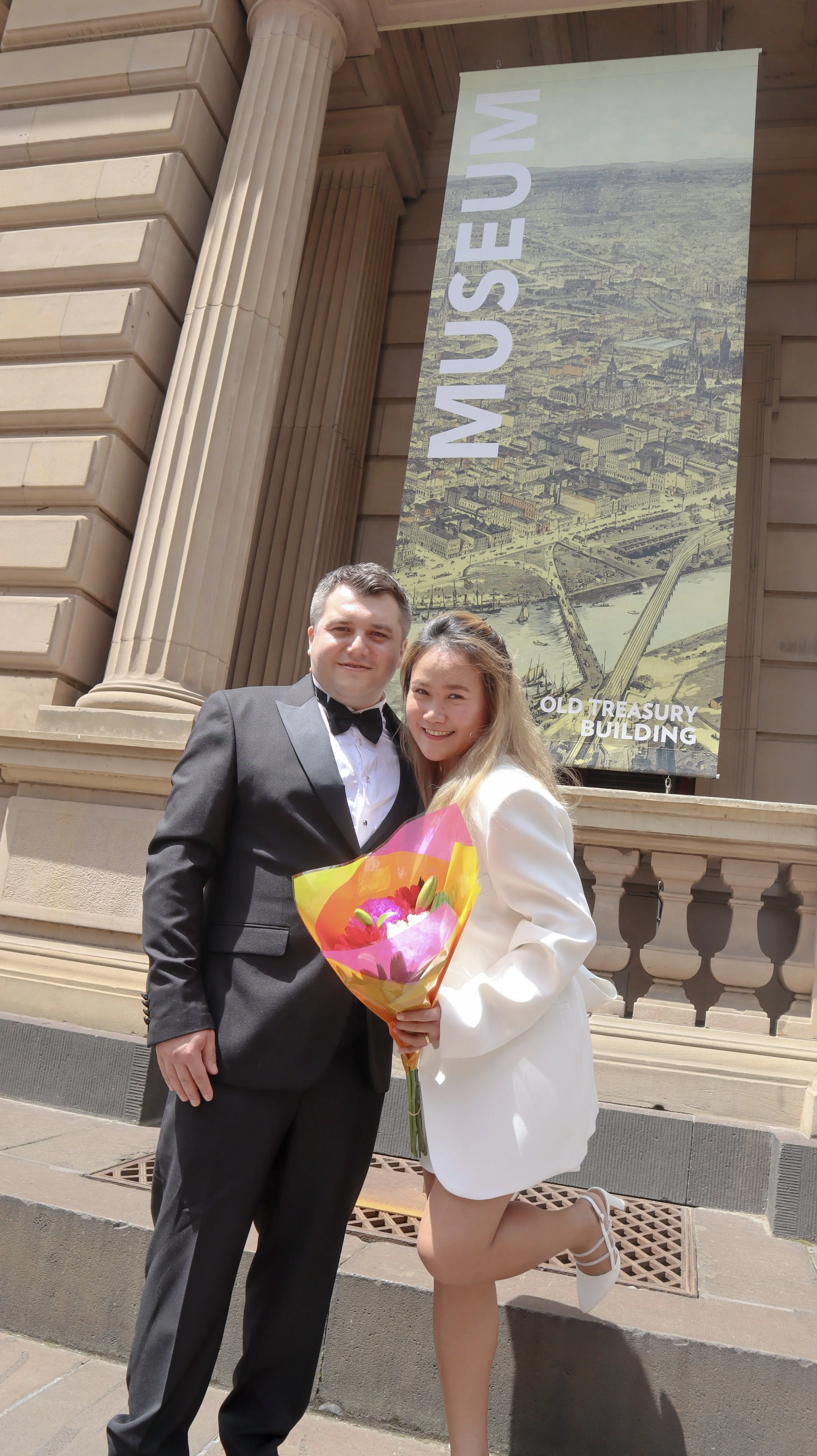 Anne's customers, Matt and Ester embracing by the Old Treasury Building