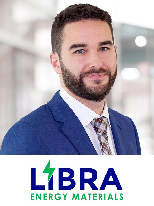 Professional man wearing a blue suit and patterned tie, smiling in an office setting, with a logo for 'LIBRA Energy Materials' below.