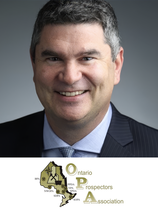 A professional headshot of a smiling man in a suit with a graphic of Ontario map and the words 'Ontario Prospectors Association' at the bottom.