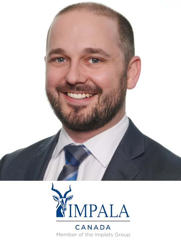 A man with a beard and short hair dressed in a suit, white shirt, and striped tie smiling against a white background. The IMPALA Canada logo and text are at the bottom.