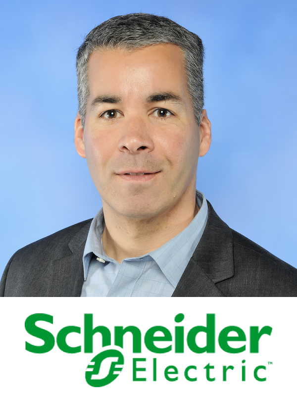Professional headshot of a man with short gray hair, wearing a dark suit jacket and a light blue collared shirt, standing in front of a blue background, with a Schneider Electric logo at the bottom.