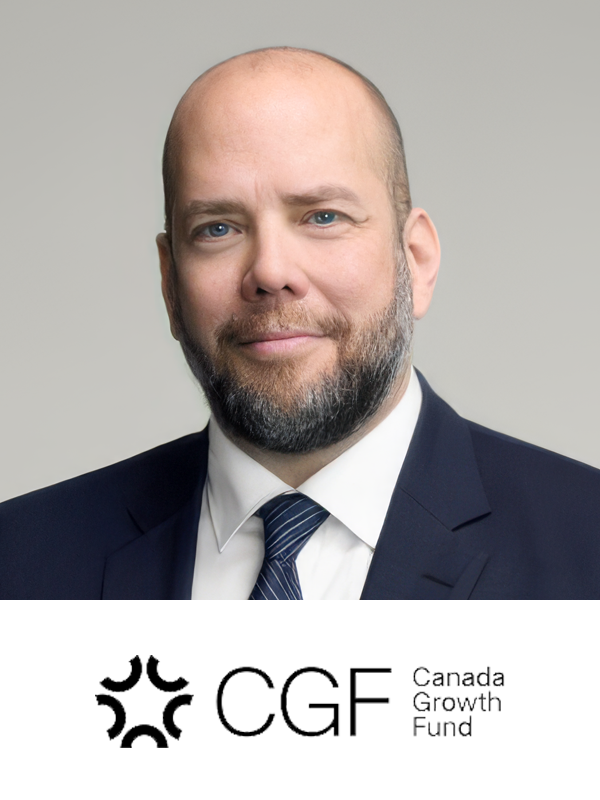 A man with a beard and bald head wearing a dark suit, white shirt, and striped tie, smiling against a plain gray background. The logo of the Canada Growth Fund is at the bottom.