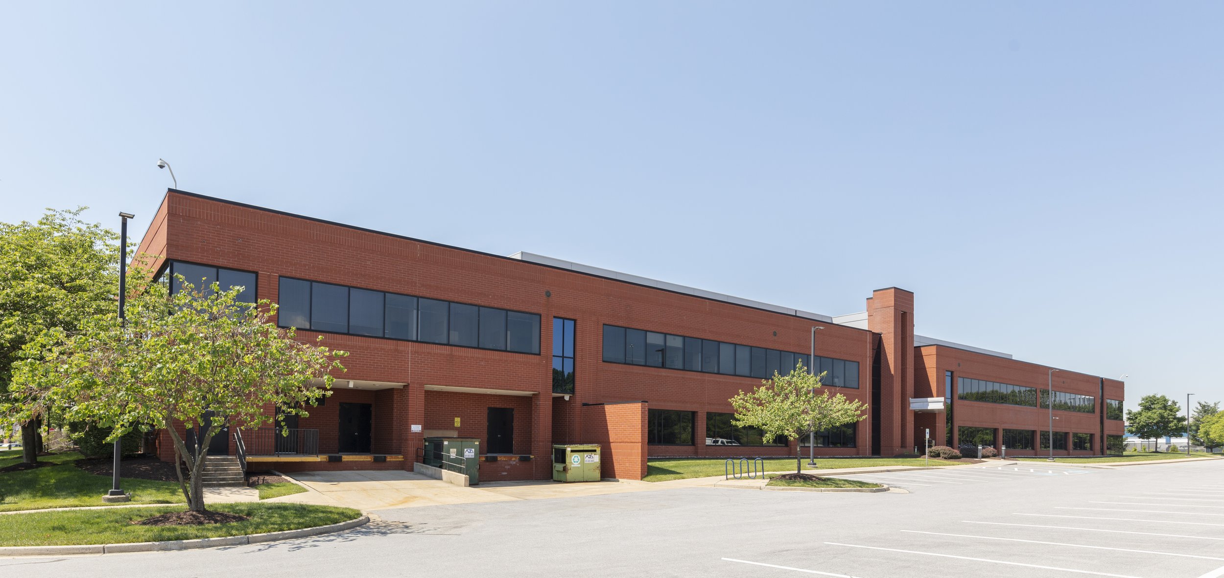 Exterior view of Ballenger Biotech Building in Frederick, Maryland, showing the life sciences property and surrounding parking area.