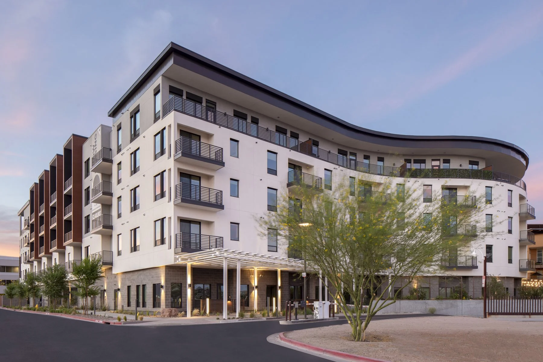 Safari Multifamily residential development in Scottsdale, Arizona, featuring a modern five-story apartment building with balconies and desert landscaping.