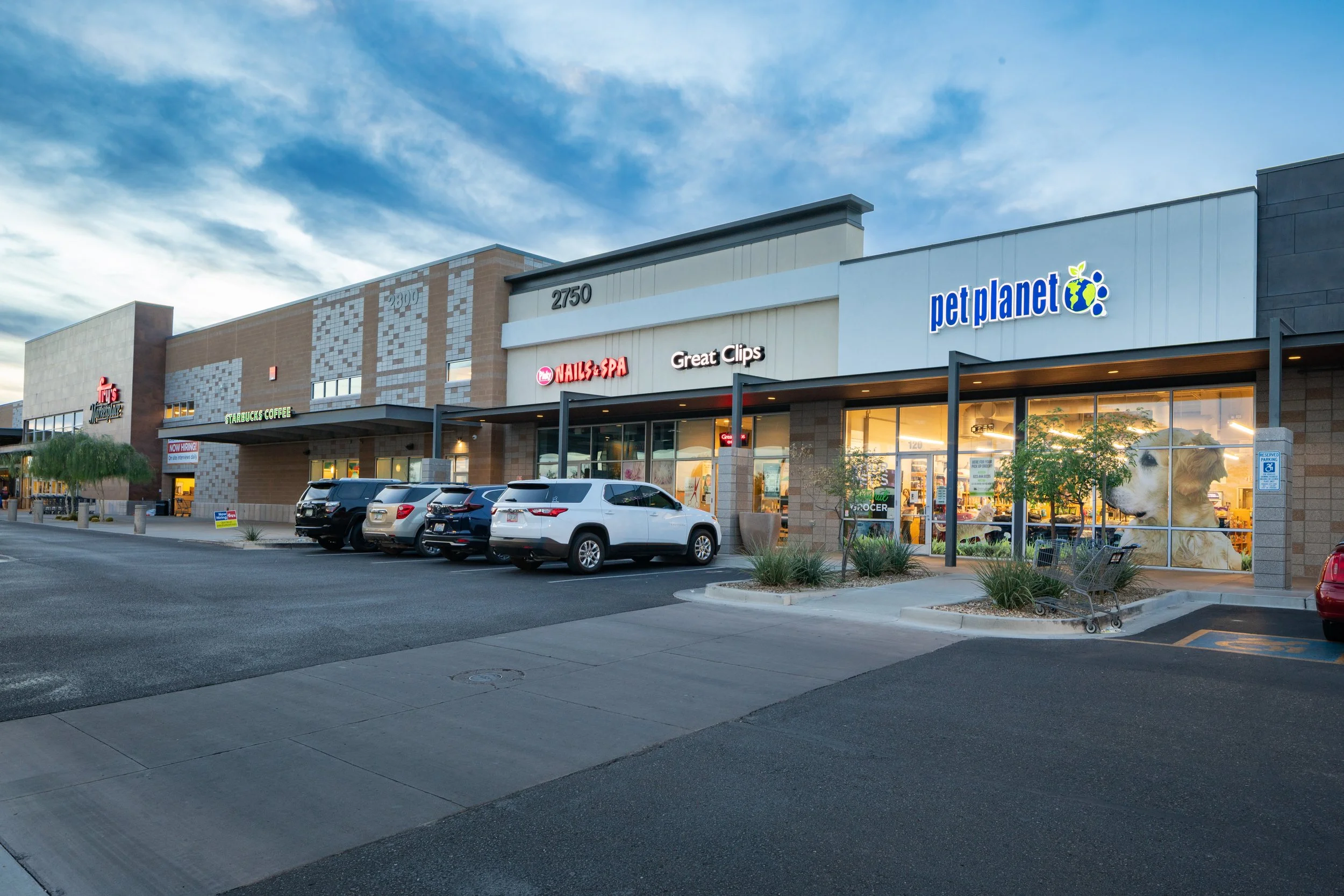 Canyon Crossroads shopping center in Phoenix, Arizona, featuring retail storefronts including Pet Planet, Great Clips, and a nail salon.
